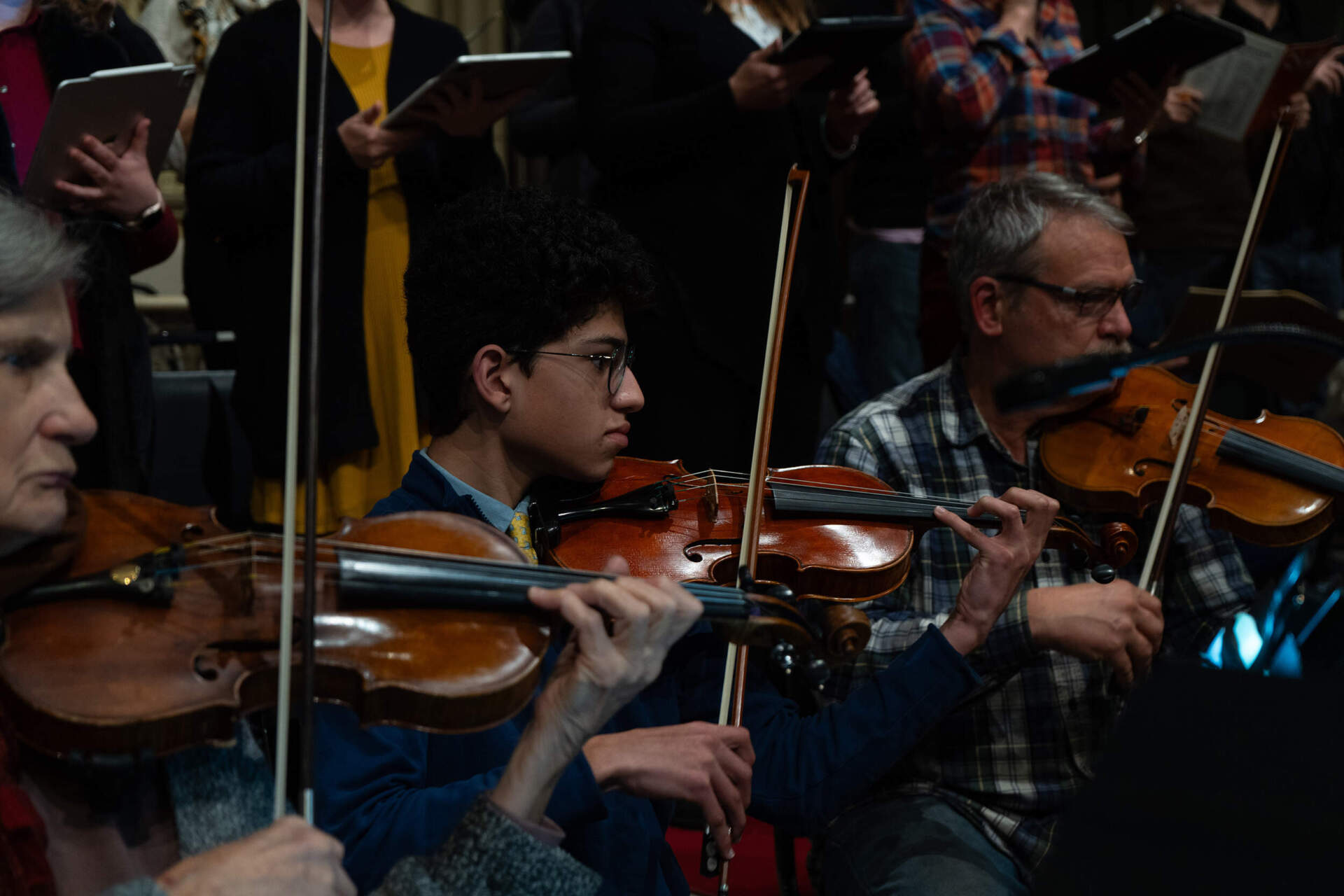 Caleb Casiano rehearses with members of Emmanuel Music at Emmanuel Church in Boston on Wednesday night. (Sydney Ko/WBUR)