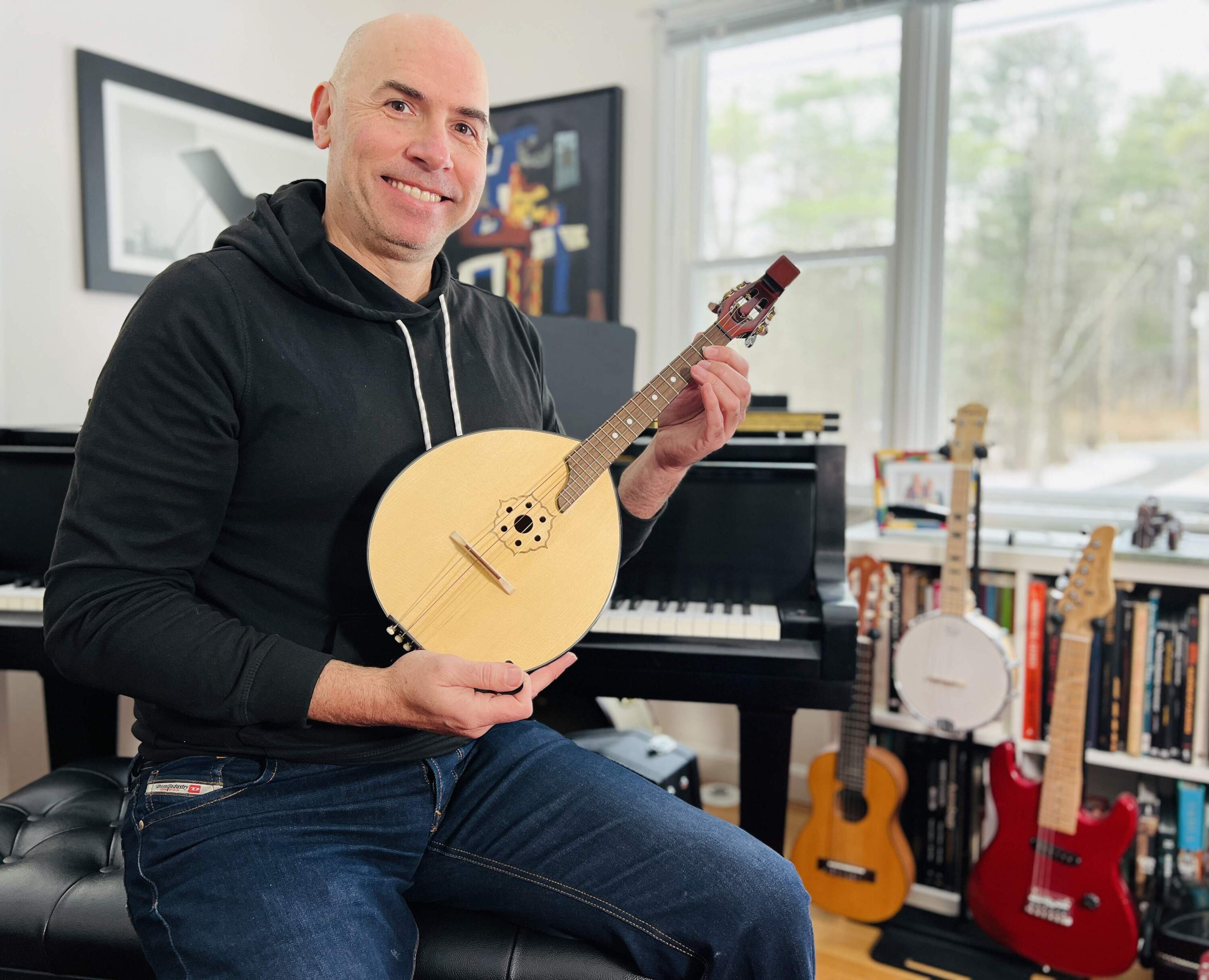 Eric Shimelonis with a domra, a stringed instrument in the lute family. (Courtesy of Rebecca Sheir)