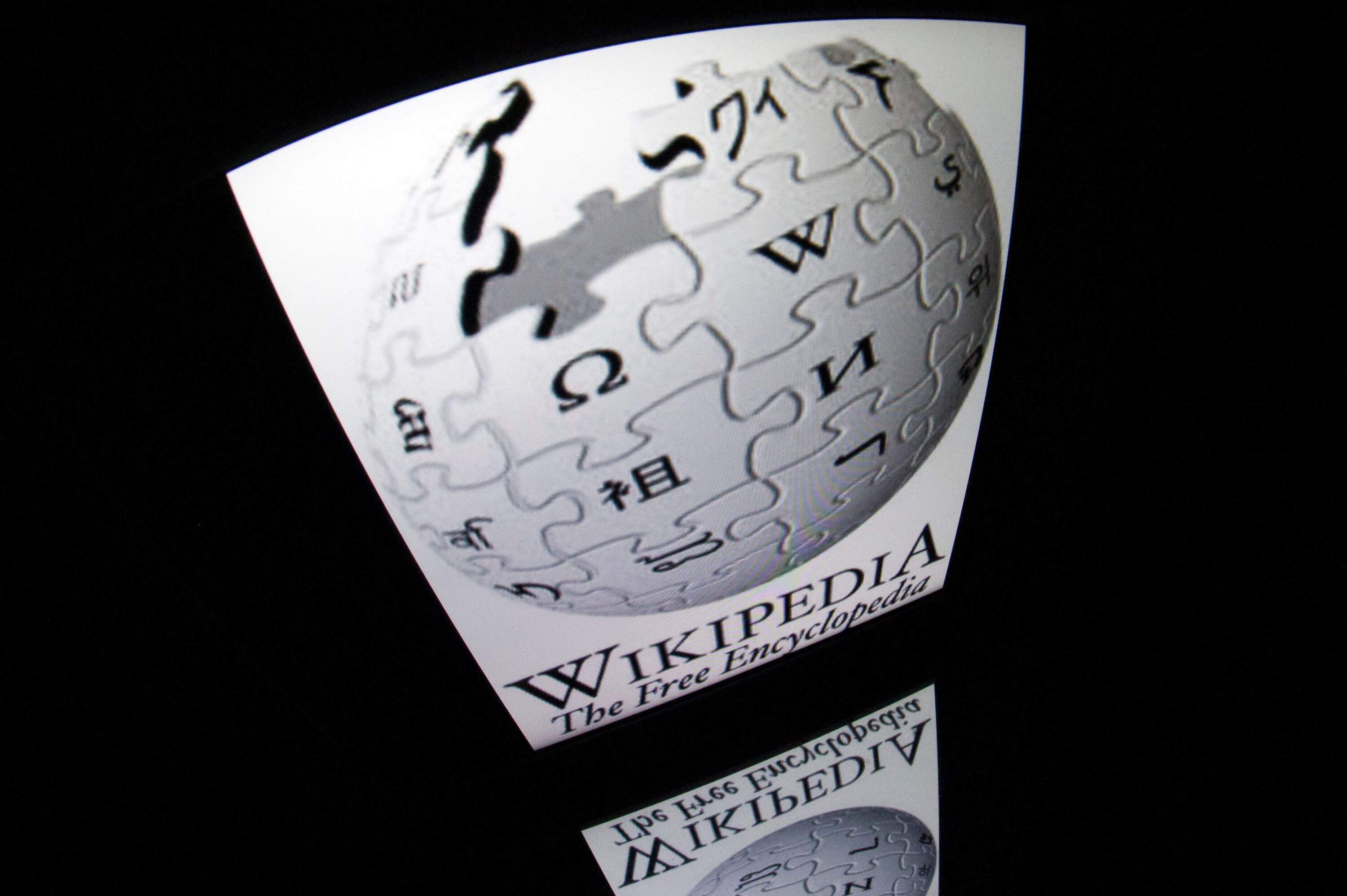 The "Wikipedia" logo is seen on a tablet screen. (Lionel Bonaventure/AFP via Getty Images)
