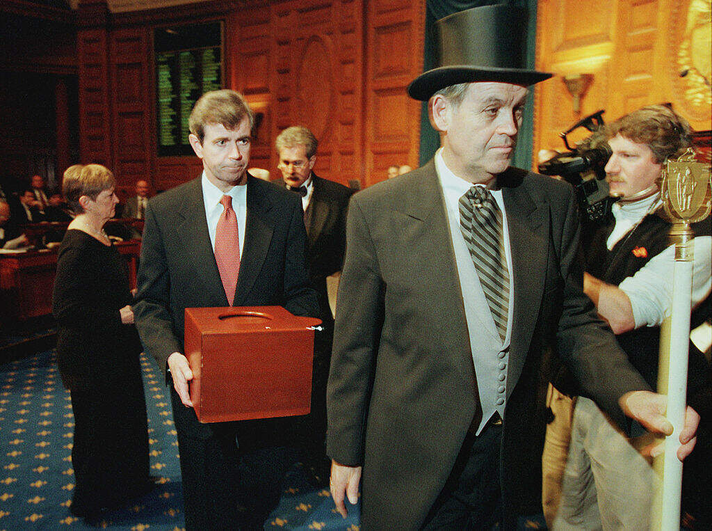 Secretary of State Bill Galvin carries a ballot box containing Massachusetts' electoral votes, led by Sergeant-at Arms Michael Rea, during the state's Electoral College meeting in 2000. (Pool Photo via Getty Images)