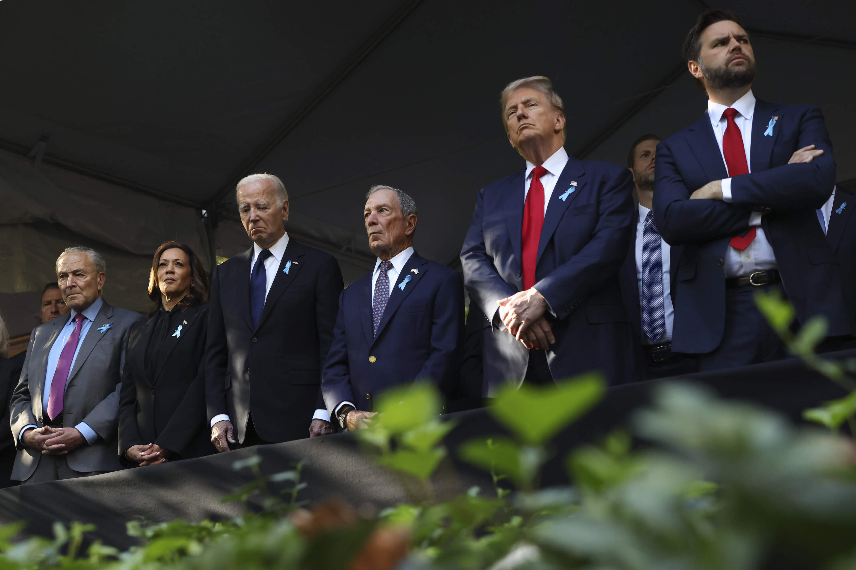 From left, Sen. Chuck Schumer, D-NY, 2024 Democratic presidential nominee Vice President Kamala Harris, President Joe Biden, Michael Bloomberg, then-Republican presidential nominee former President Donald Trump and then-Republican vice presidential nominee Sen. JD Vance, R-Ohio, attend the 9/11 Memorial ceremony on Sept. 11, 2024, in New York. (Yuki Iwamura/AP)