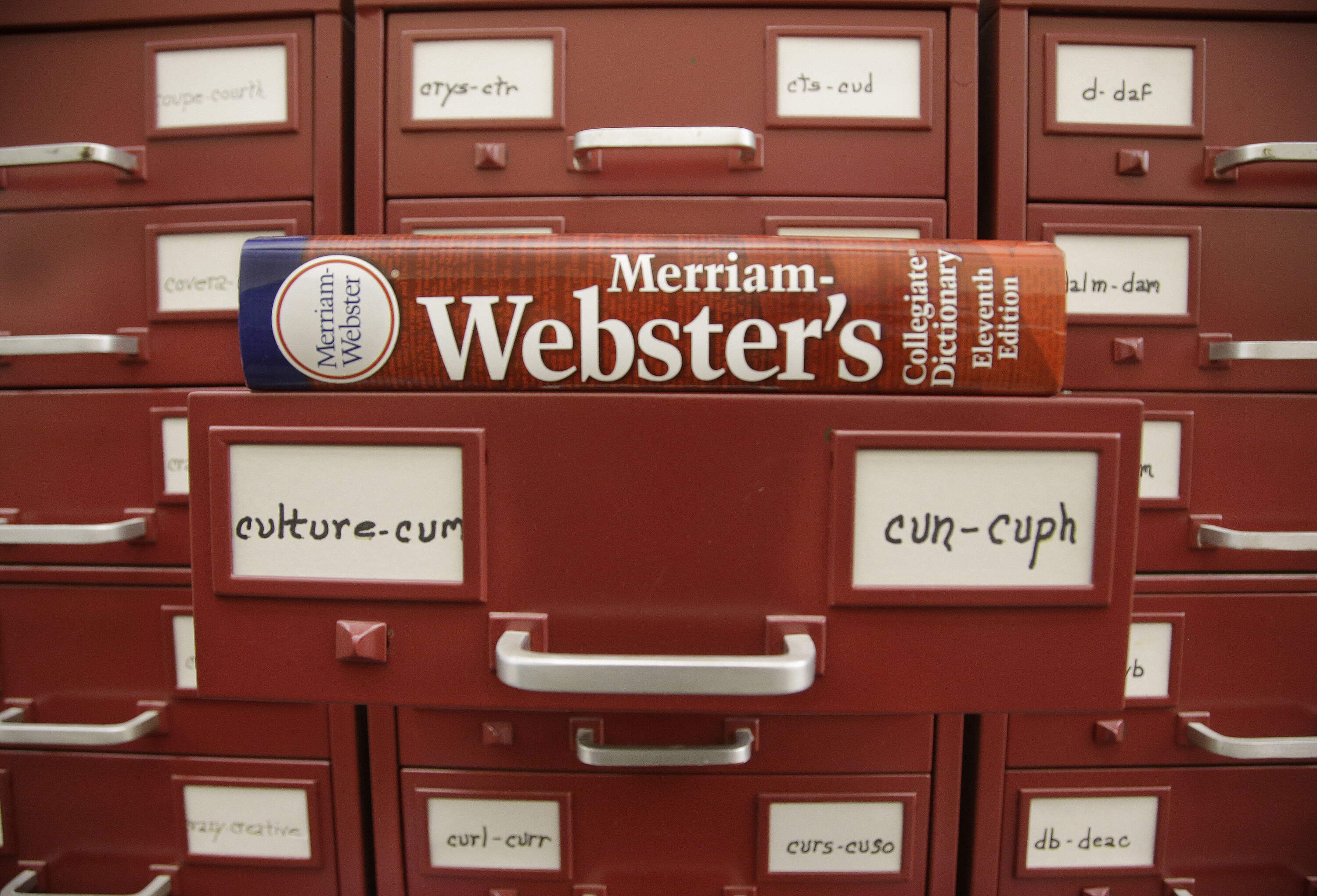A Merriam-Webster dictionary sits atop their citation files at the dictionary publisher's offices on Dec. 9, 2014, in Springfield, Mass. (Stephan Savoia/AP)