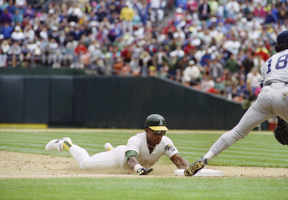 Oakland Athletics' Rickey Henderson, left, goes sliding into third base to steal his 939th career base to set an all-time major league record, May 1, 1991. (Eric Risberg/AP)