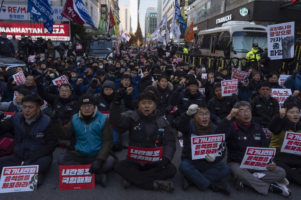 Protesters against South Korean President Yoon Suk Yeol gather outside the ruling People Power Party headquarters in Seoul, South Korea, Friday, Dec. 6, 2024. (AP Photo/Ng Han Guan)