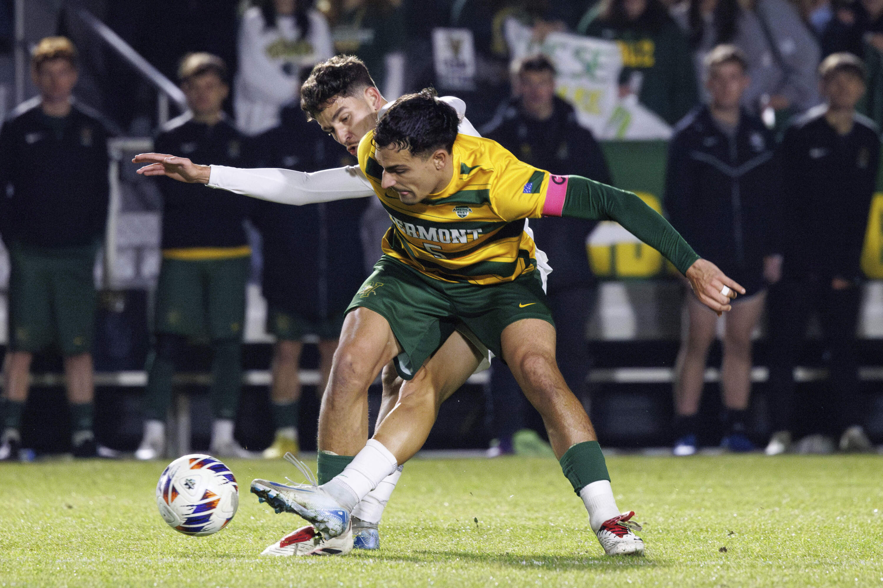 Vermont's Adrian Schulze Solano (5) and Marshall's Lineker Rodrigues dos Santos, left, battle for a ball during the first half of the NCAA College Cup National Championship soccer final. (Ben McKeown/AP)