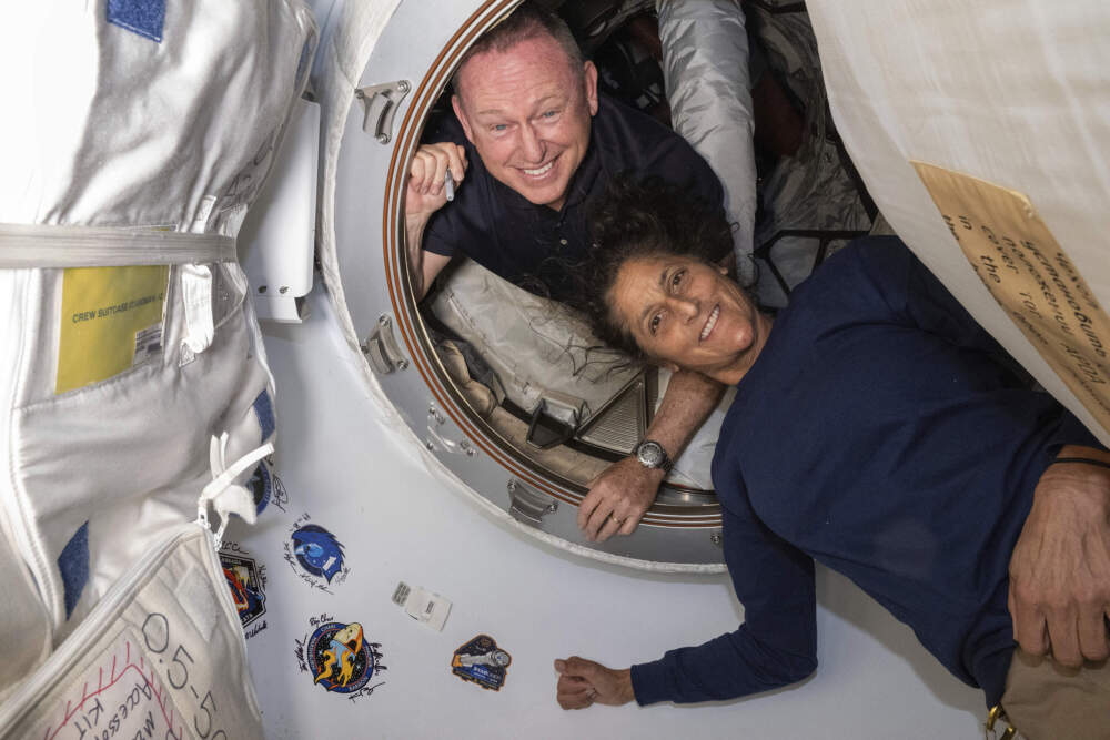 In this photo provided by NASA, Boeing Crew Flight Test astronauts Butch Wilmore, left, and Suni Williams pose for a portrait inside the vestibule between the forward port on the International Space Station's Harmony module and Boeing's Starliner spacecraft on June 13. (NASA via AP file photo)