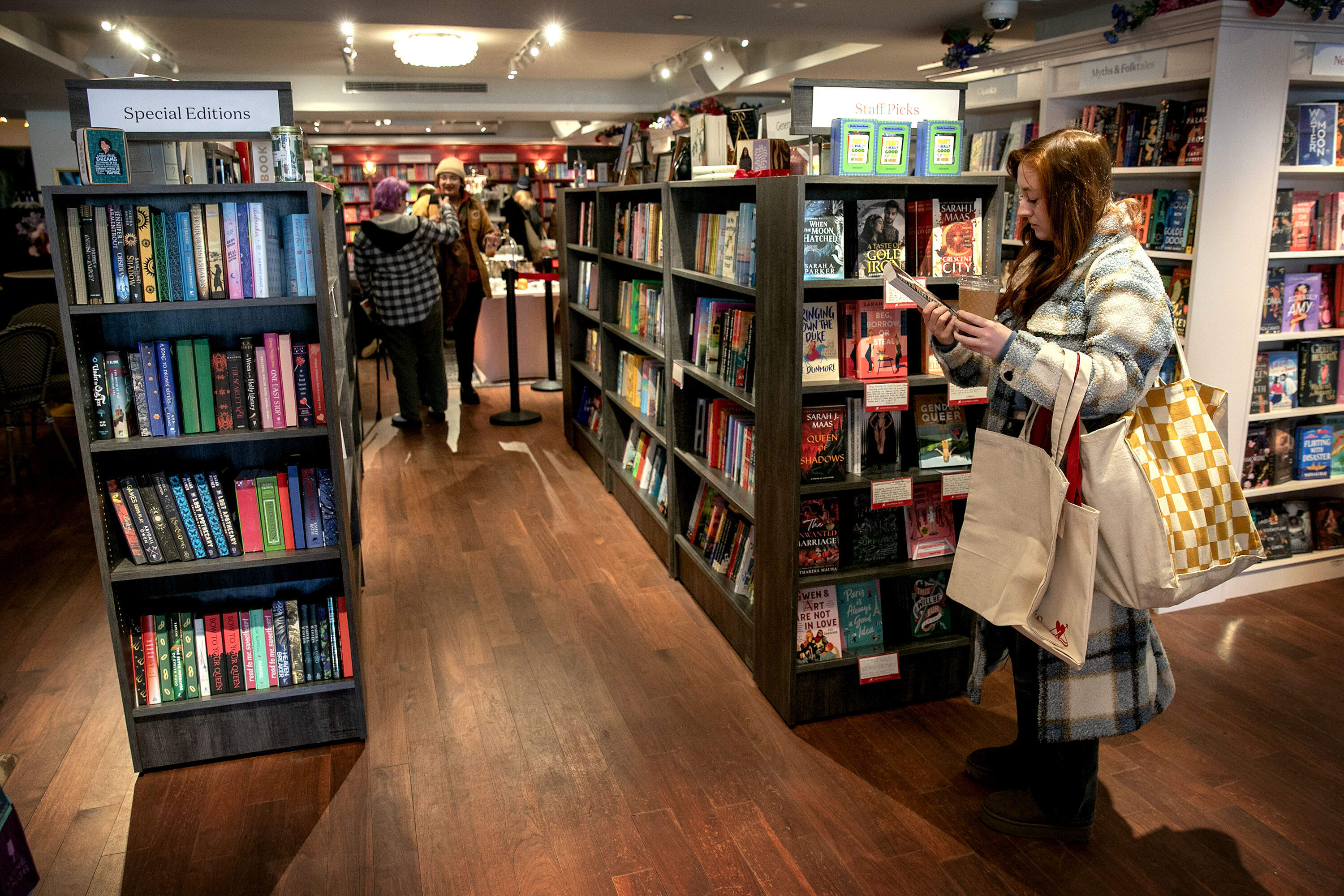 Customers look through books at Lovestruck Books in Cambridge, Mass. (Robin Lubbock/WBUR)