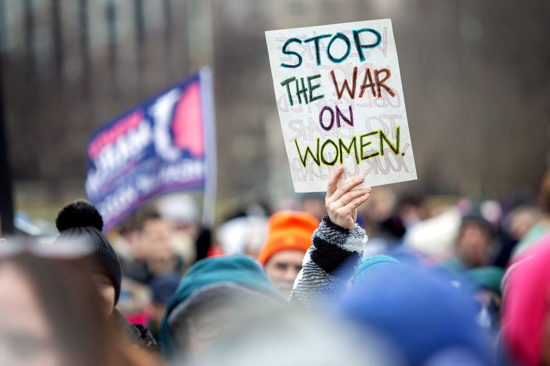 A woman holds up a sign at the People's March on Boston Common. (Robin Lubbock/WBUR)