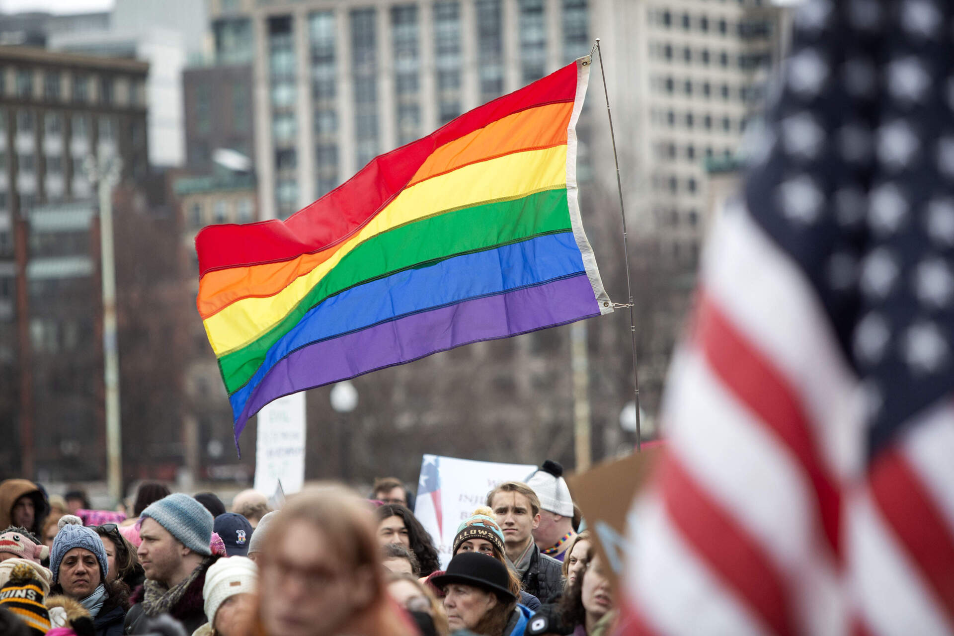A rainbow flag is hoisted up by a protester and floats over several participants' heads during the march on Boston Common. (Robin Lubbock/WBUR)