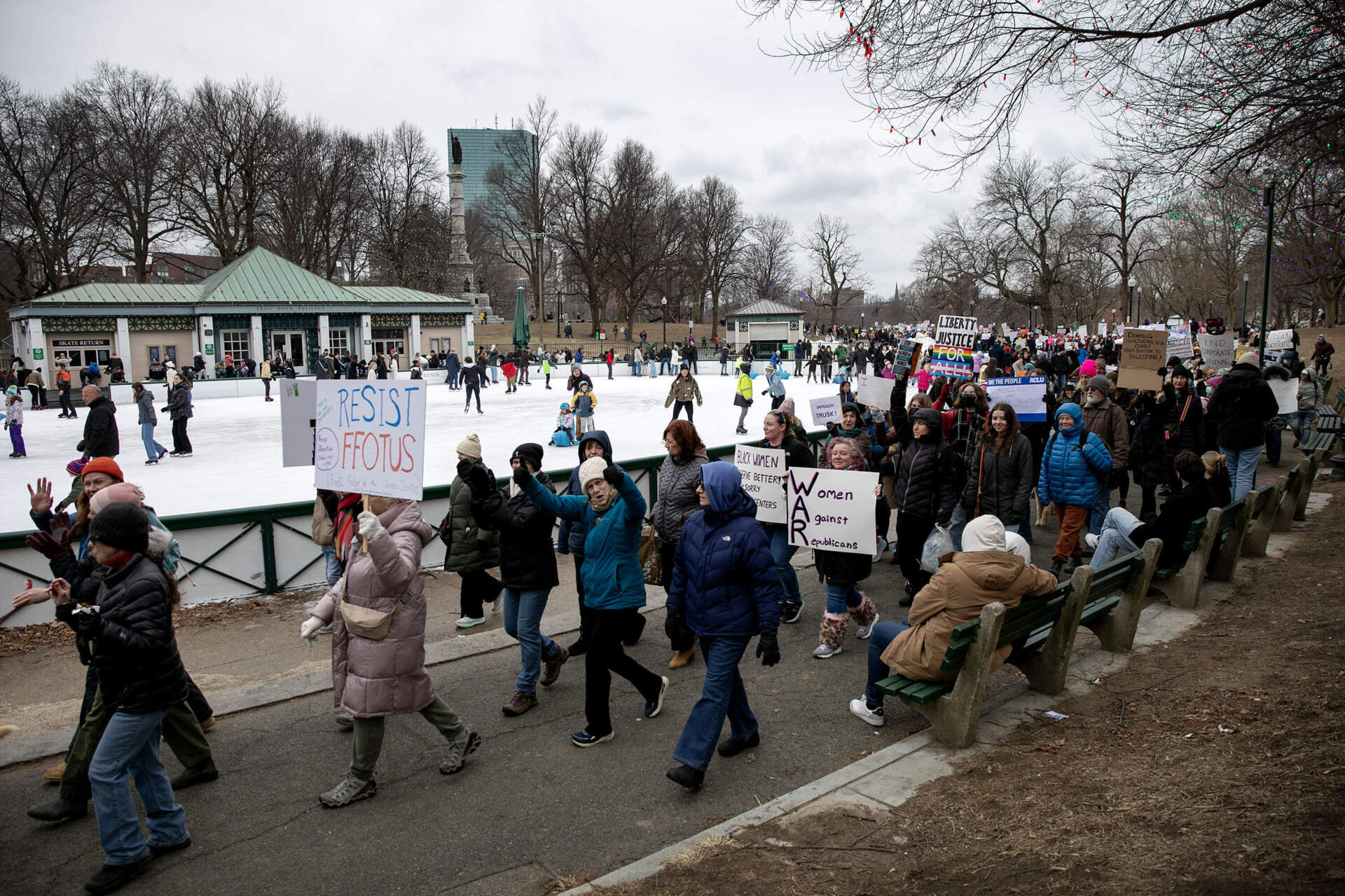 People's March protesters walk past the Frog Pond on their way across Boston Common. (Robin Lubbock/WBUR)