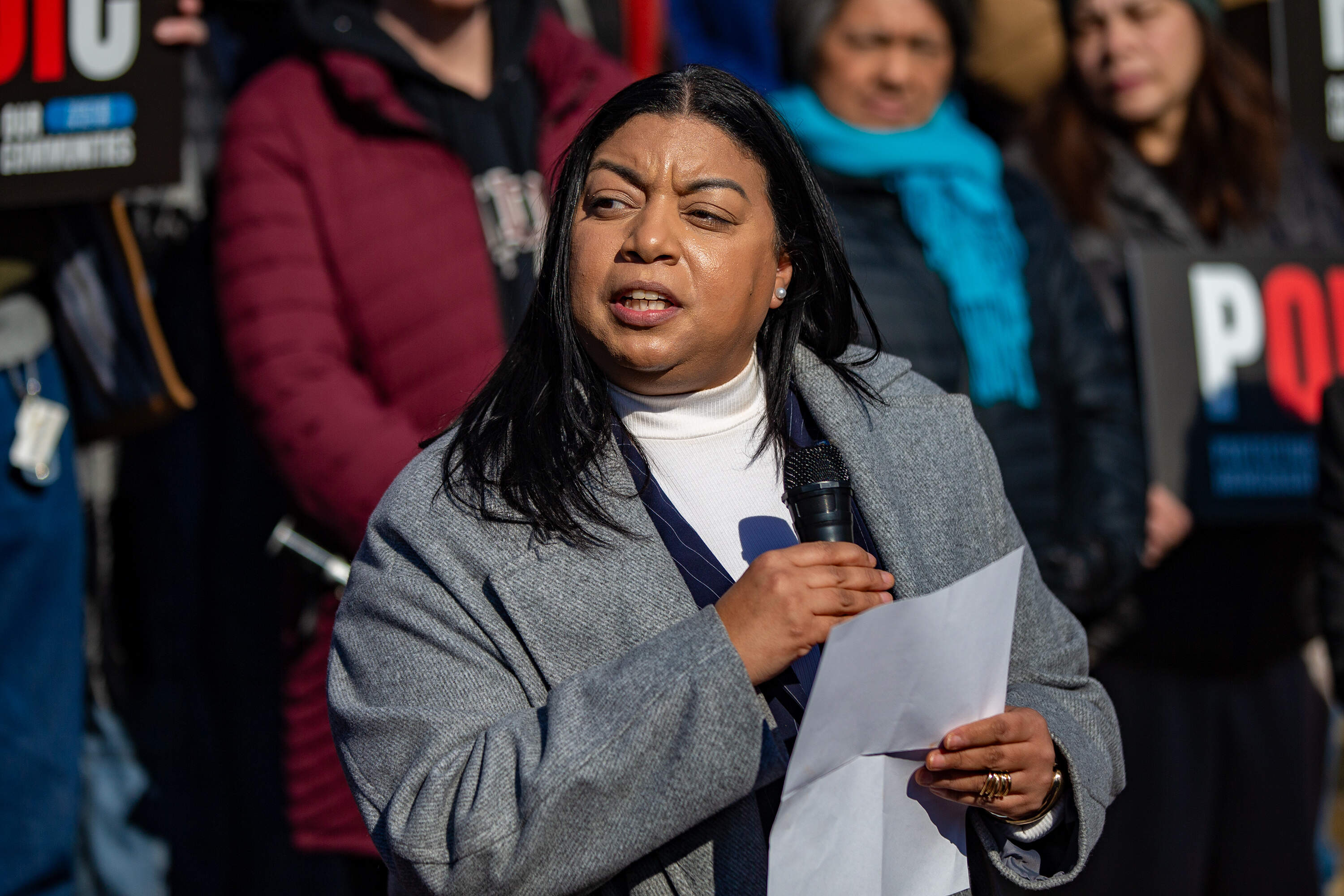 State Sen. Liz Miranda speaks during the MIRA rally on the steps of the State House. (Jesse Costa/WBUR)