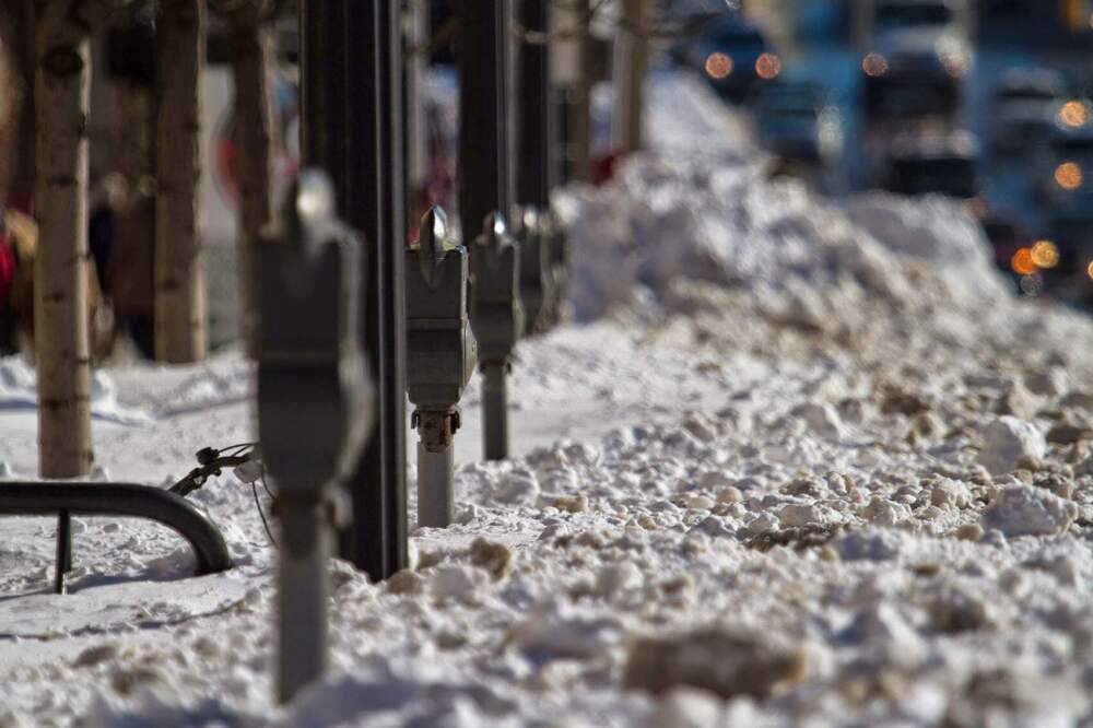 Several parking meters were buried in snow along Commonwealth Ave. as Boston continued snow removal efforts following a blizzard on Jan. 27, 2015. (Jesse Costa/WBUR)