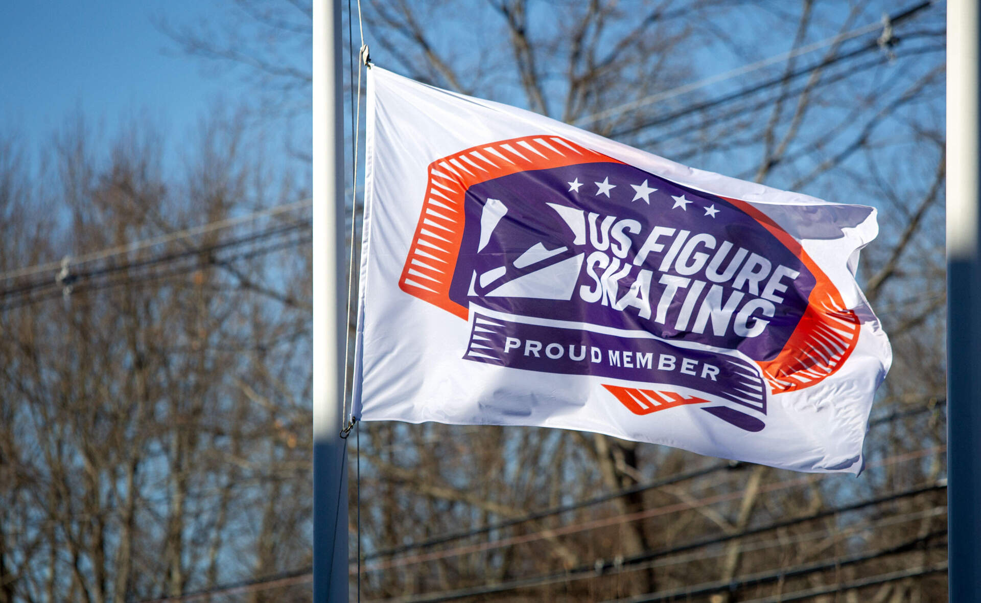 The U.S. Figure Skating flag flies at half staff outside the Skating Club of Boston, in Norwood. (Robin Lubbock/WBUR)