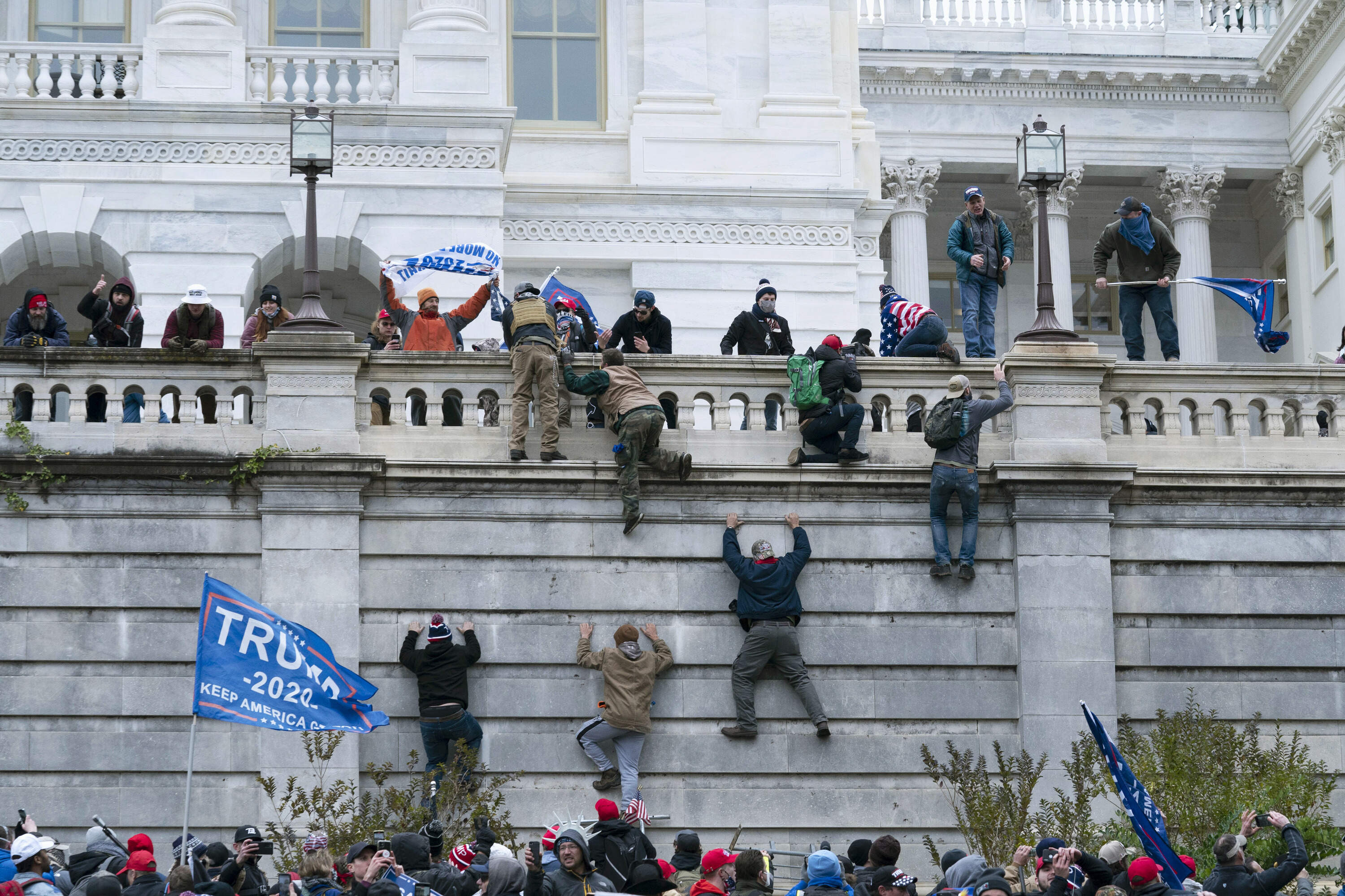 Violent insurrectionists loyal to President Trump scale the west wall of the the U.S. Capitol in Washington on Jan. 6. 2021. (Jose Luis Magana/AP)