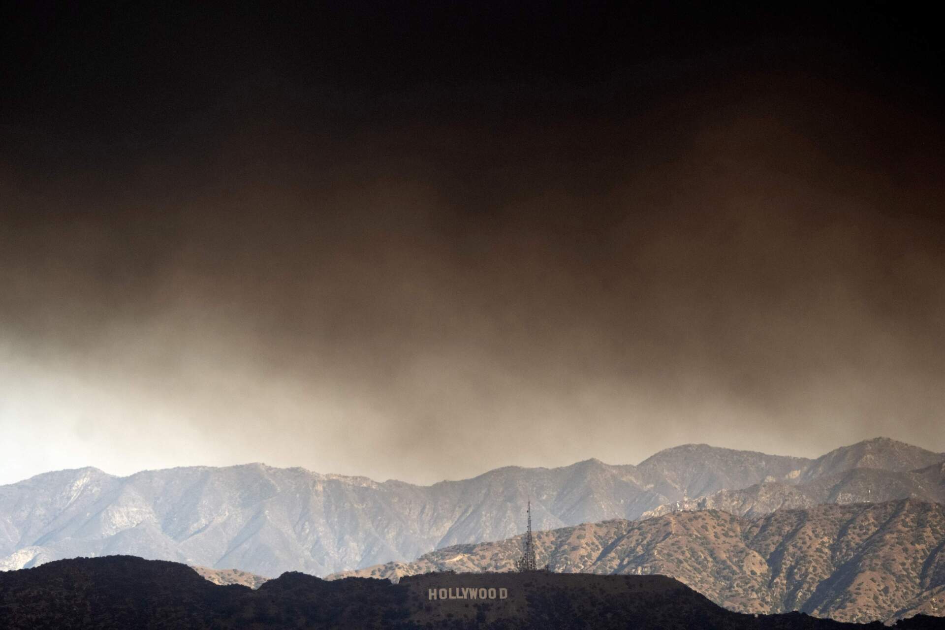 Thick heavy smoke from wildfires passes over the Hollywood sign in Los Angeles on Wednesday, Jan. 8, 2025. (Richard Vogel/AP)