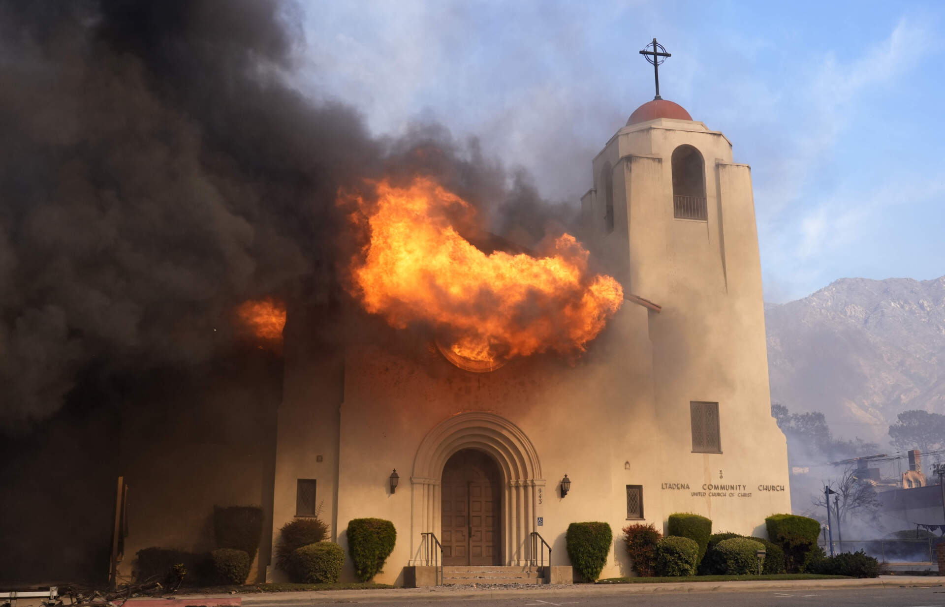 Fire explodes out of a window of the Altadena Community Church, Wednesday in the downtown Altadena section of Pasadena, Calif. (Chris Pizzello/AP)