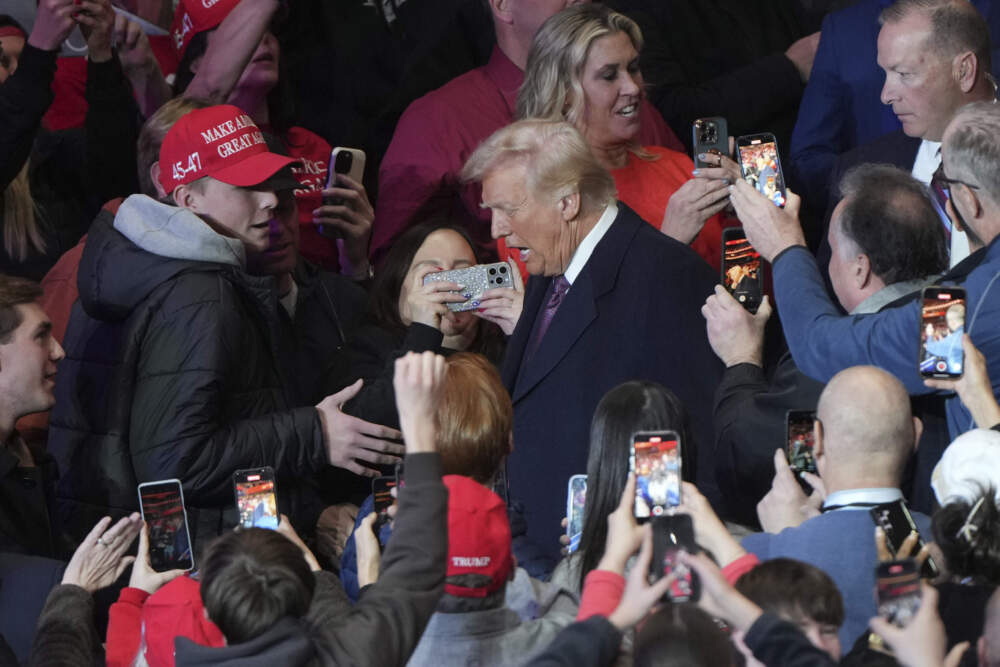 President Trump greets supporters as he arrives at an indoor Presidential Inauguration parade event on Monday. (Matt Rourke/AP)