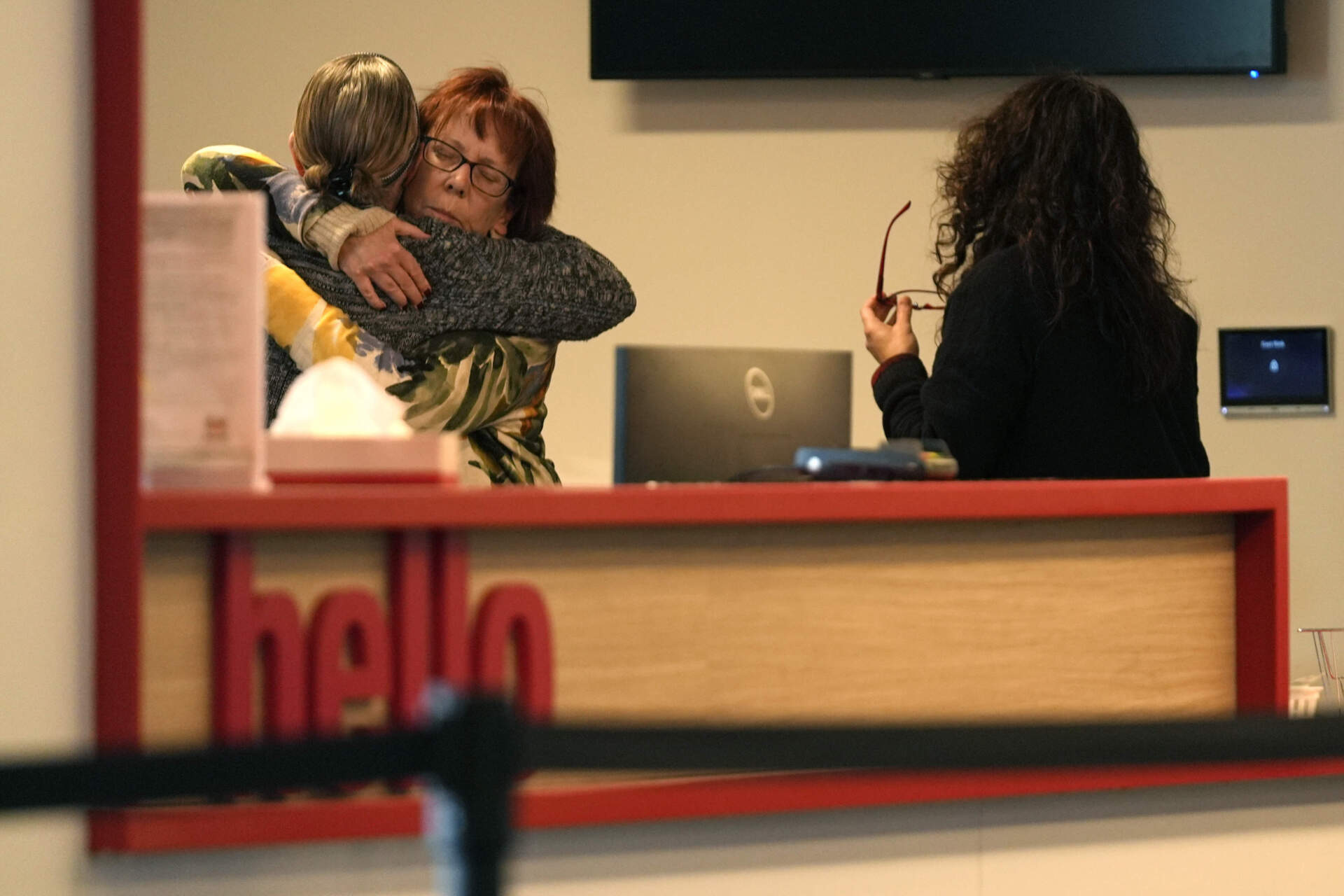 Women embrace in the reception area of The Skating Club of Boston, Jan. 30, 2025. (Robert F. Bukaty/AP)