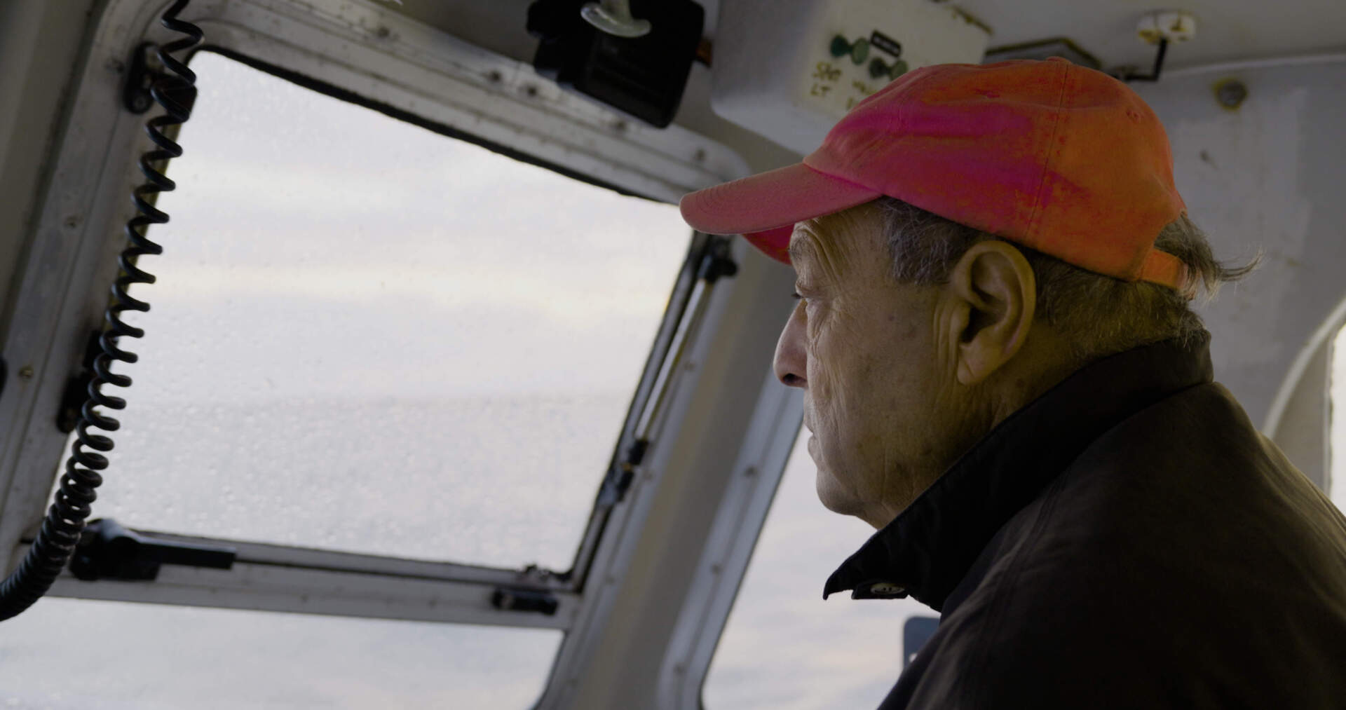 Bill Amaru at the helm of his fishing boat. (Duy Linh Tu for WBUR)