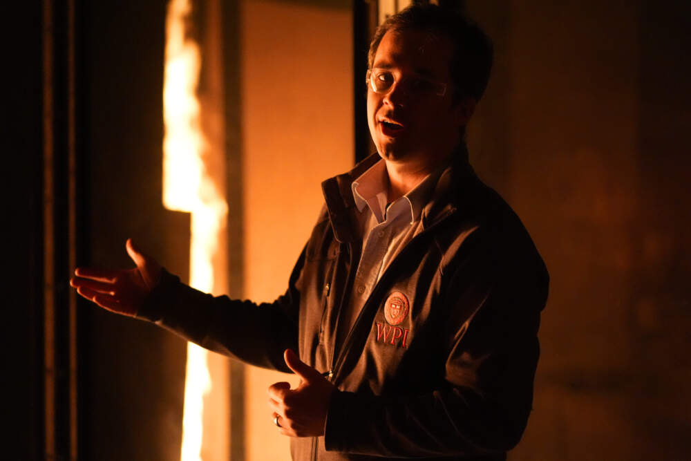 James Urban, assistant professor in the department of Fire Protection Engineering at Worcester Polytechnic Institute, comments during a controlled burn in a lab. (Robert F. Bukaty/AP)