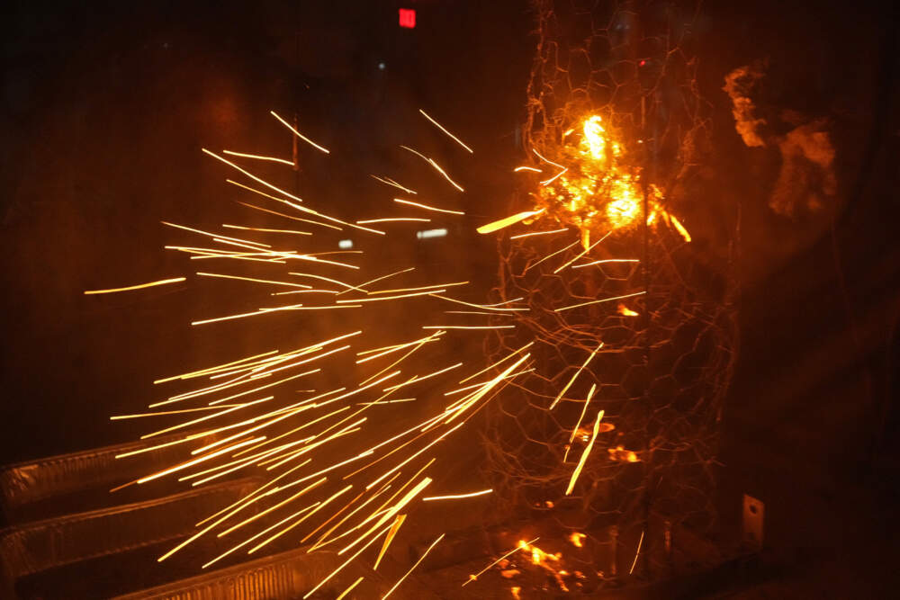 Sparks fly during a controlled burning of brush in a wind tunnel in lab at Worcester Polytechnic Institute. (Robert F. Bukaty/AP)