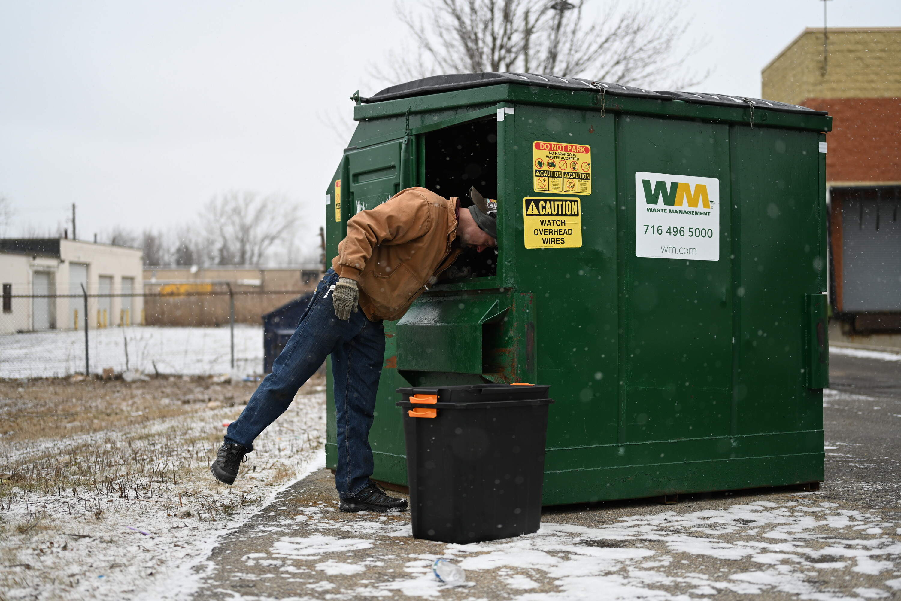 Dave Sheffield pushes aside trash in hopes of finding something valuable. (Chris Bentley/Here &amp; Now)