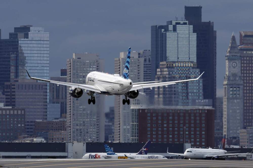 A plane lands at Logan International Airport in Boston. (Michael Dwyer/AP)