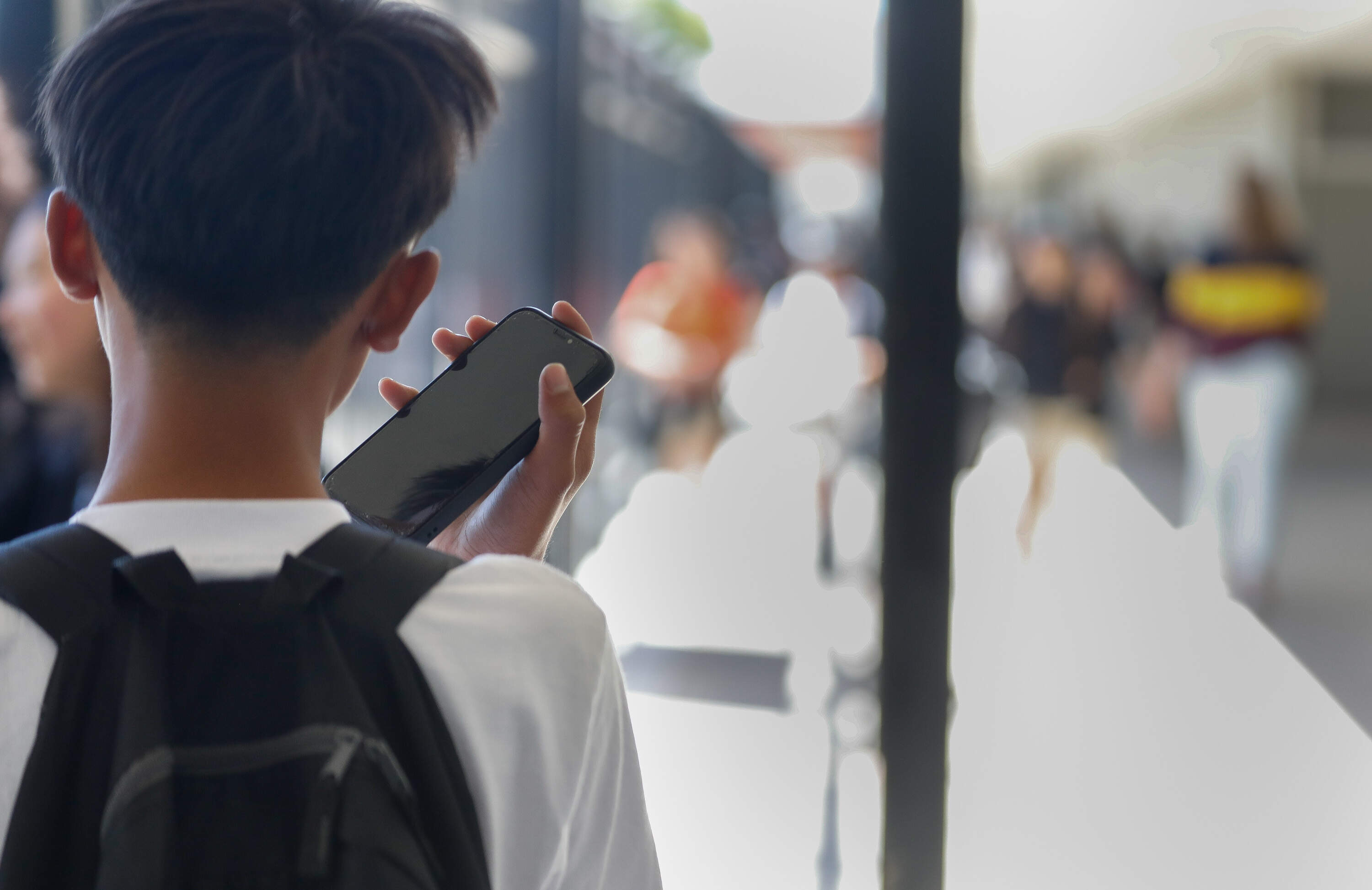 A student uses a cellphone at school. (Lea Suzuki/San Francisco Chronicle via Getty Images)
