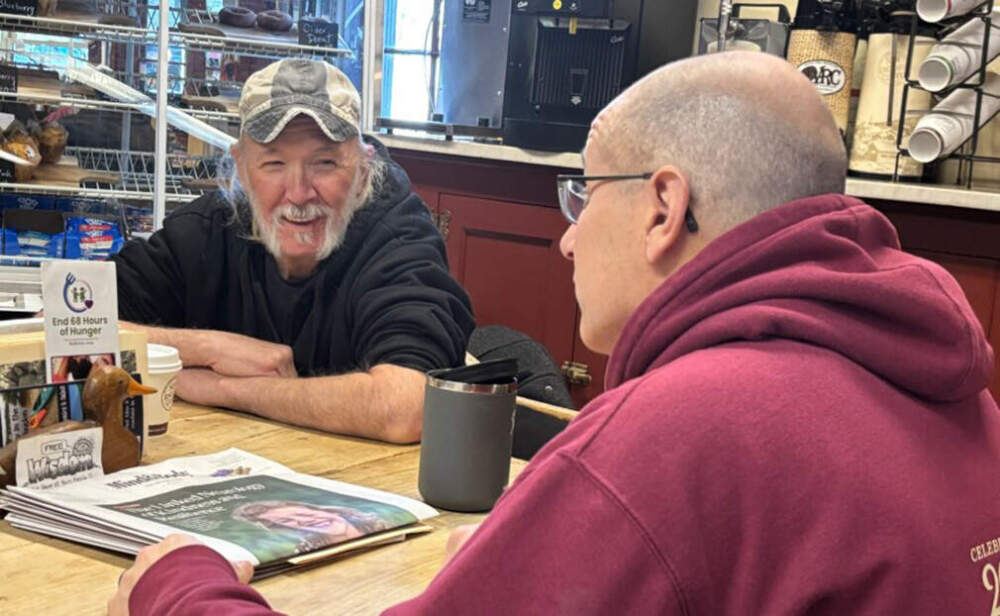 Guy Pike, left, catches up with Dave Dauphinais. (Annmarie Timmins/NHPR)
