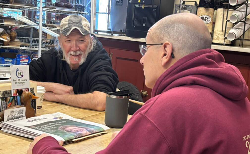 Guy Pike, left, catches up with Dave Dauphinais. (Annmarie Timmins/NHPR)