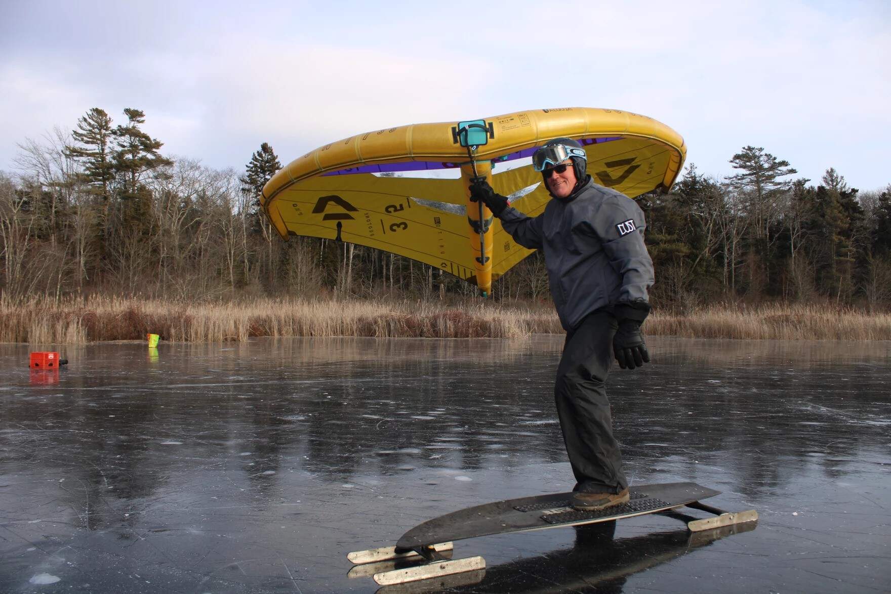 Frank Whittier, of Cumberland, on Great Pond in Cape Elizabeth on Tuesday, Jan. 7. Whittier said he's been skate sailing since the late 1980s, and has rarely seen ice conditions this good. (Ari Snider/Maine Public)