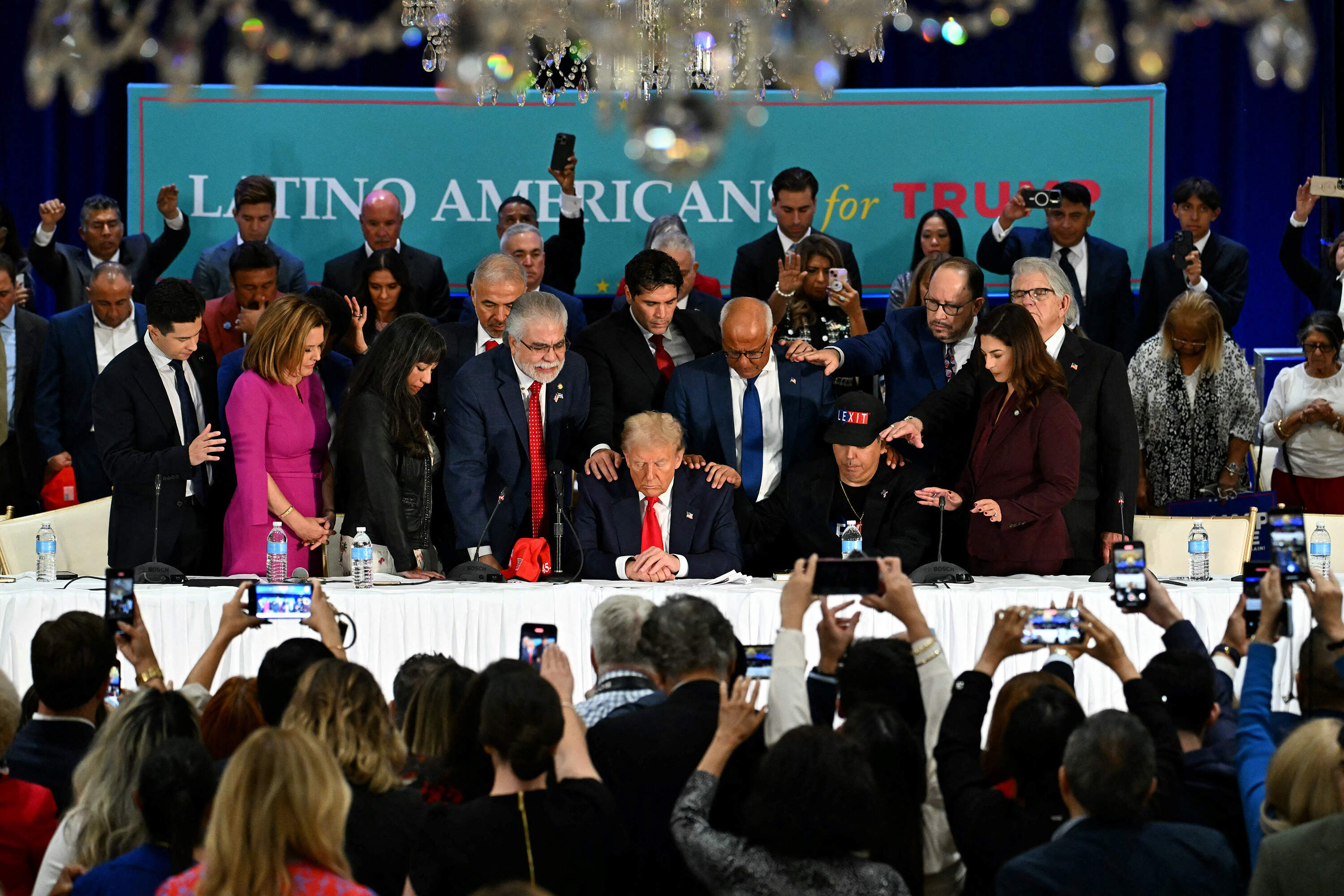 Former President Donald Trump prays during a roundtable discussion with Latino community leaders at Trump National Doral Miami resort in Miami, Florida, on Oct. 22, 2024. (Chandan Khanna/AFP via Getty Images)