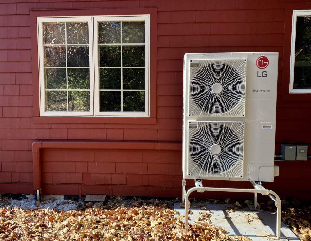 A heat pump condenser outside of a building in Lincoln, Mass. (Miriam Wasser/WBUR)