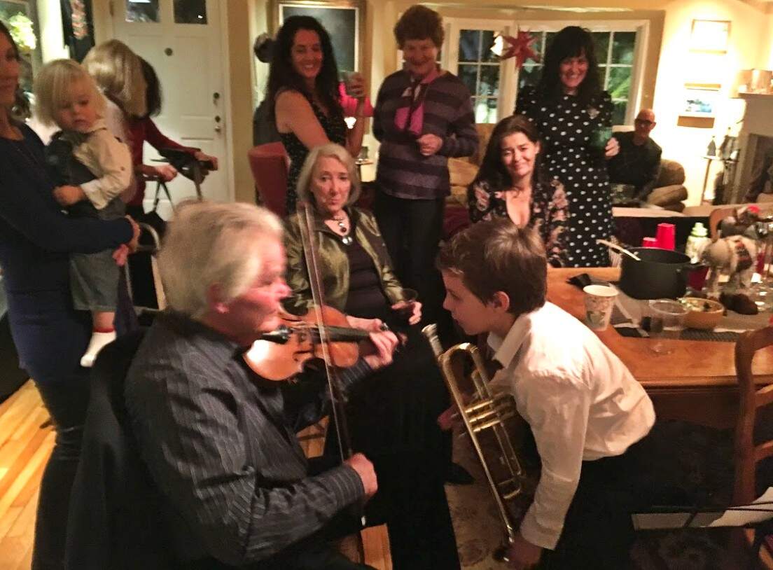 A scene from the author's family's annual Christmas Eve party at their home in the Pacific Palisades. The author's late father, Michael Meyer, is playing the violin. (Courtesy Andrea Meyer)