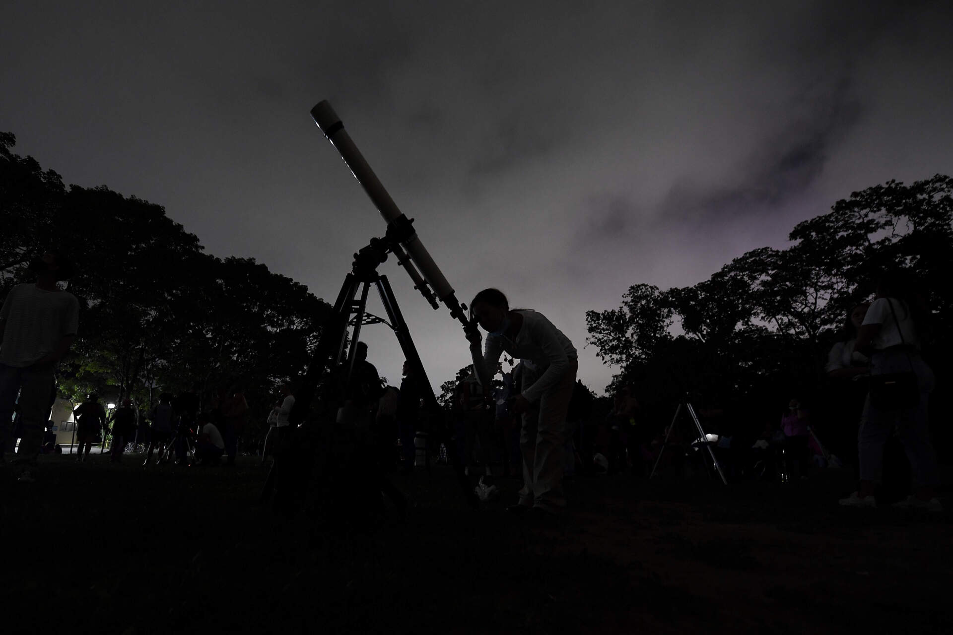 A girl looks at the moon through a telescope in Caracas, Venezuela, on May 15, 2022. (Matias Delacroix/AP)