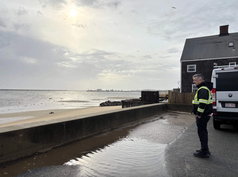 Jim Vincent, Provincetown's DPW director, looks out over towards the ocean in the East End. During recent storms, powerful waves have breached this low sea wall, sending flood waters into nearby homes and businesses. (Eve Zuckoff/CAI)