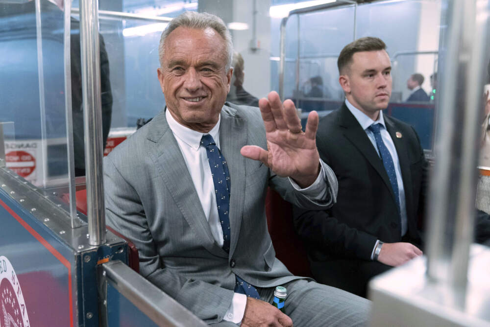 Robert F. Kennedy Jr., waves to reporters as he rides the train to go to meet with Sen. John Thune, R-S.D. at the Capitol in Washington on Dec. 17, 2024. (Jose Luis Magana/AP)