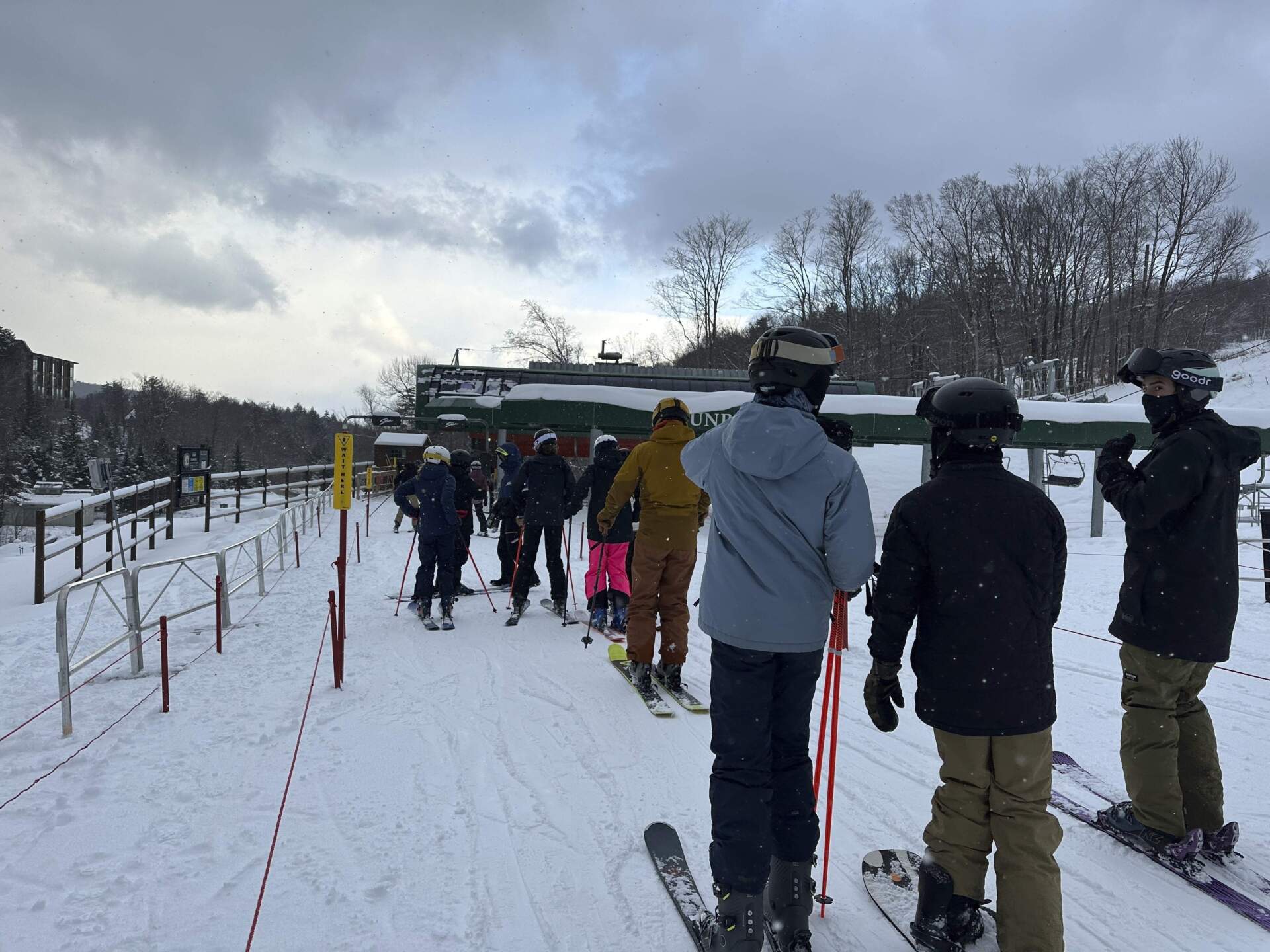 Skiers line up to get on a chairlift at Stowe Mountain Resort in Stowe, Vermont. (Lisa Rathke/AP)