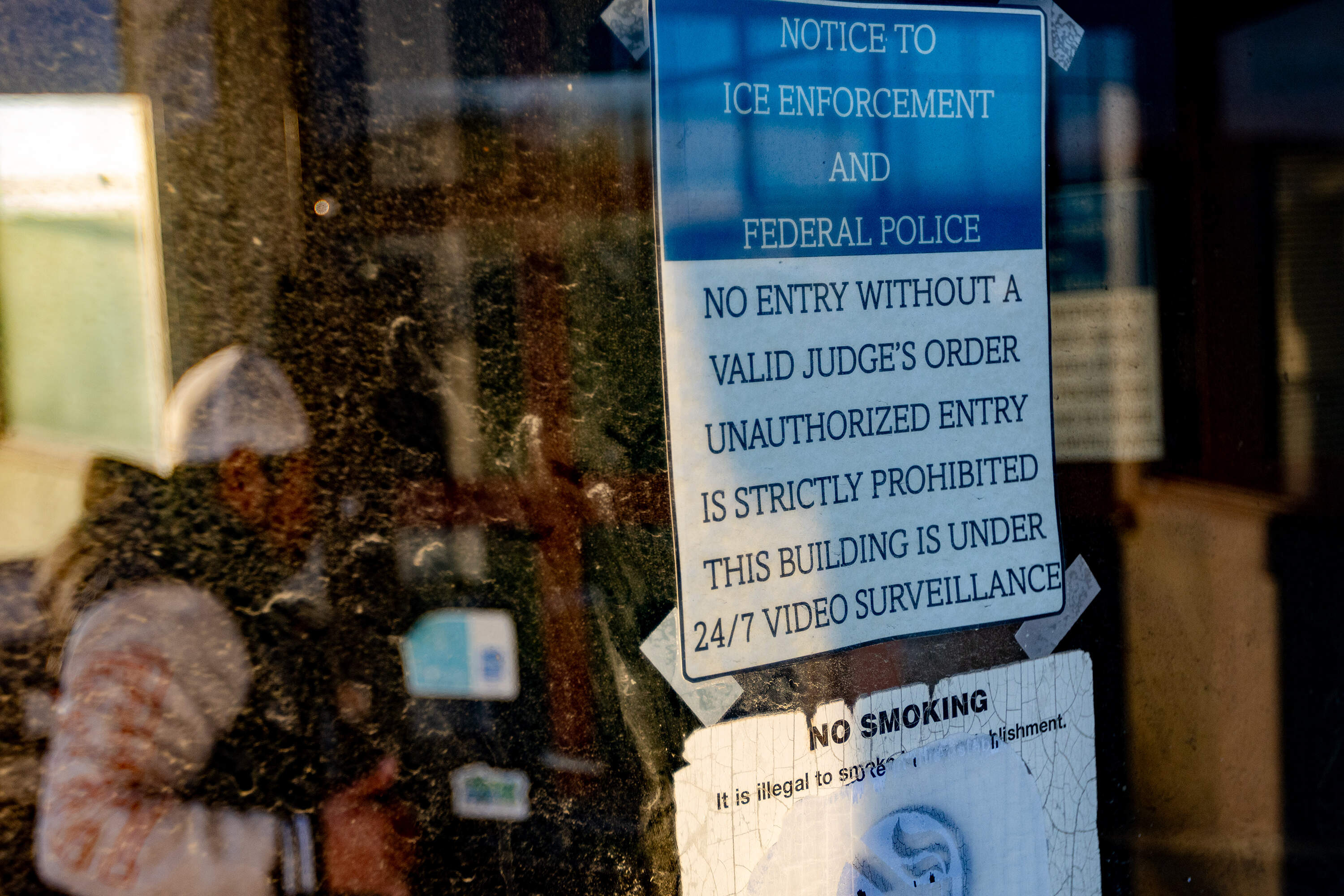 A sign in immigration attorney Jennifer Velarde's office in New Bedford requested ICE and federal police to not enter the building without a judge's order. (Jesse Costa/WBUR)