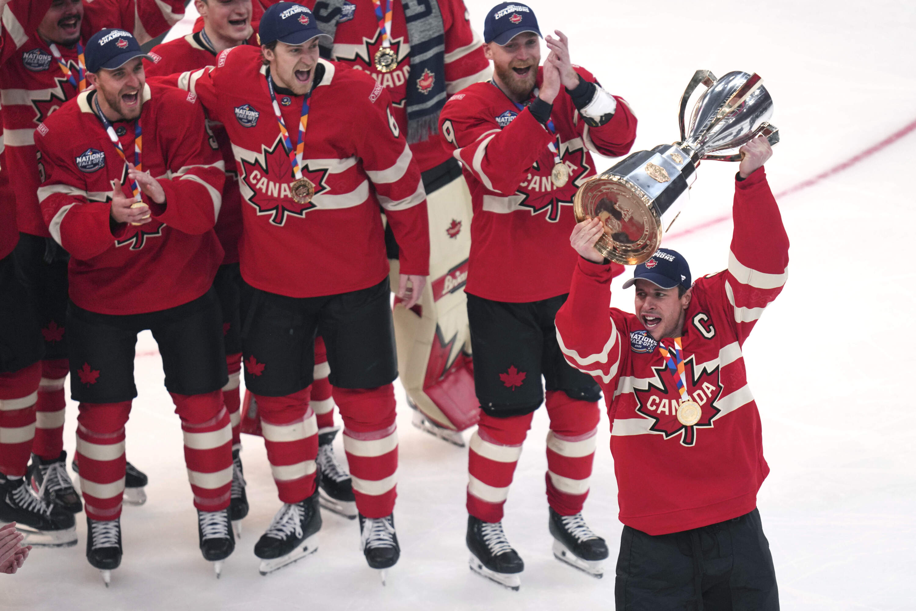 Canada captain Sidney Crosby, right, hoists the trophy after defeating the United States following an overtime period of the 4 Nations Face-Off championship hockey game, Thursday, Feb. 20, 2025, in Boston. (Charles Krupa/AP)
