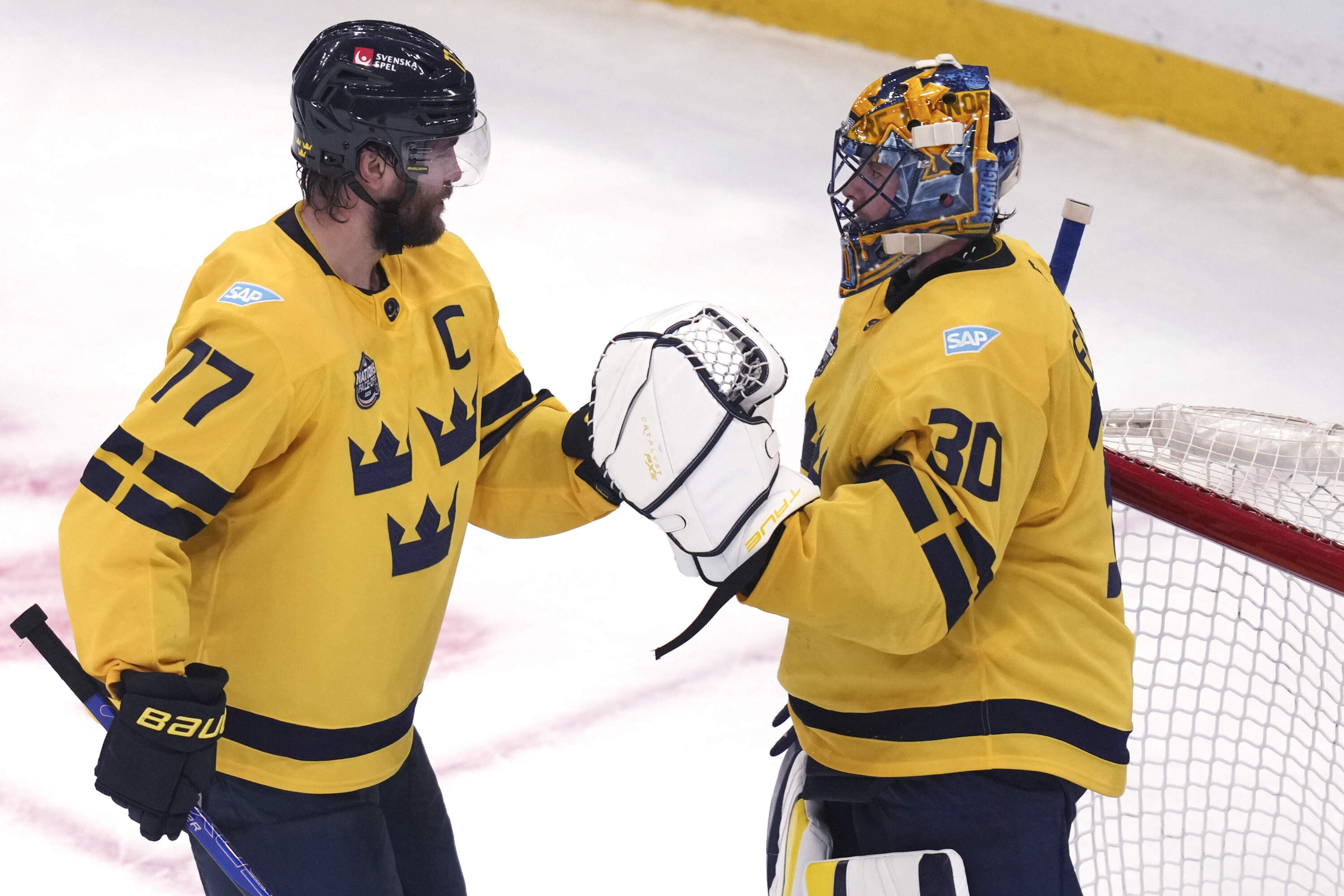 Sweden goaltender Samuel Ersson, right, is congratulated by Victor Hedman after defeating the United States in a 4 Nations Face-Off hockey game. (Charles Krupa/AP)
