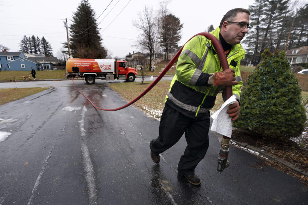 Daniel DiDonato, a deliveryman for Heatable, brings heating oil to a home in Lewiston, Maine. (Robert F. Bukaty/AP)