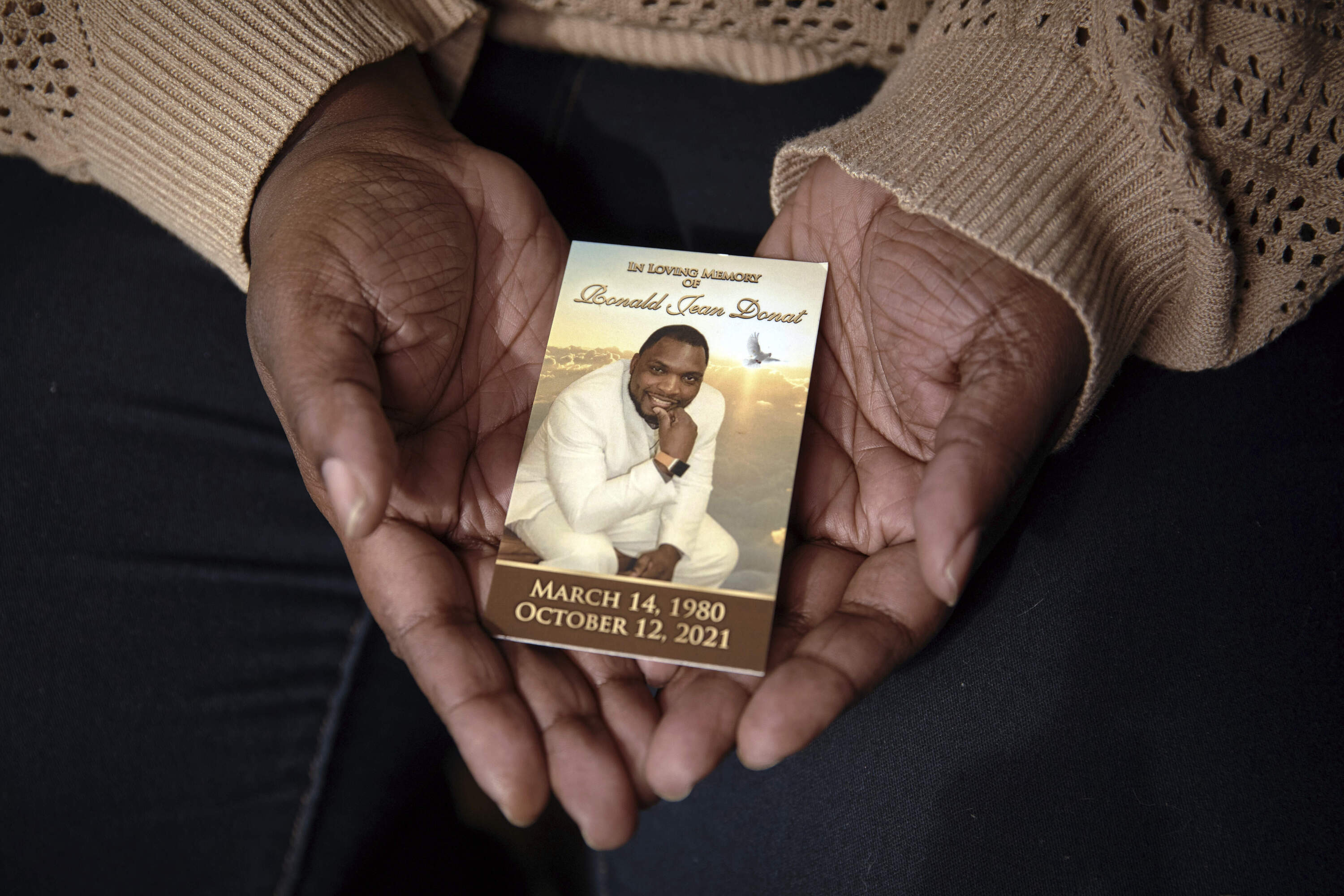 Widow Sharline Volcy holds a picture of her deceased husband, Roland Donat, Monday, Feb. 3, 2025, in Orange, N.J. (Andres Kudacki/AP)