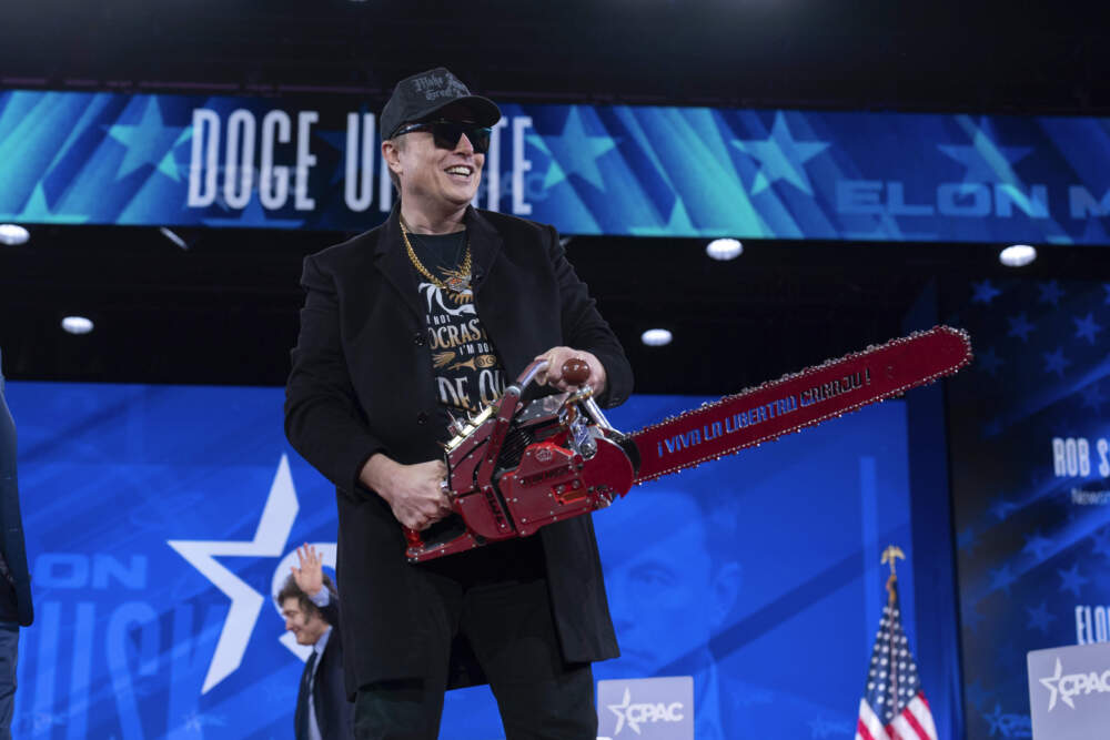 Elon Musk holds a chainsaw at the Conservative Political Action Conference (CPAC) at the Gaylord National Resort & Convention Center in Oxon Hill, Md., on Thursday, Feb. 20, 2025. (Jose Luis Magana/AP)
