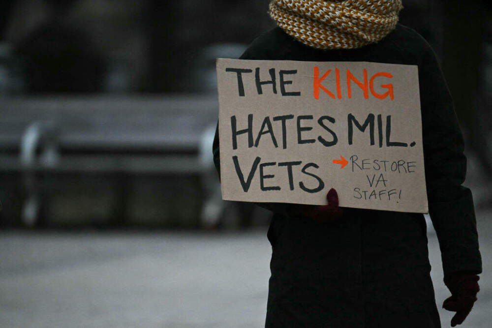 A protestor holds a sign during a demonstration against the policies of Donald Trump, Elon Musk and the Department of Government Efficiency (DOGE) in Washington, DC, on February 19, 2025. (Jim Watson/AFP via Getty Images)