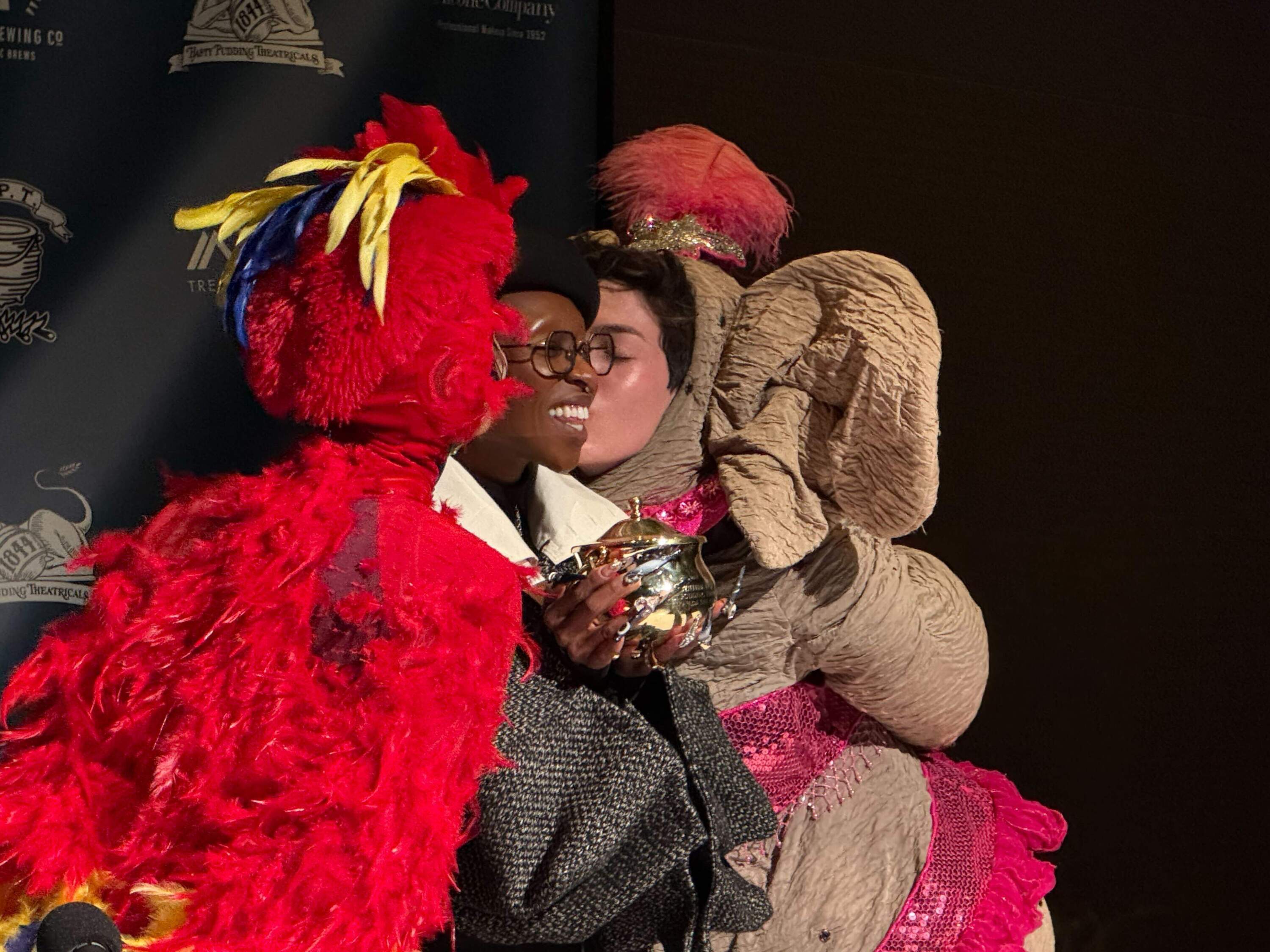 Actors kiss Cynthia Erivo on the cheeks at a press conference after the show. (Maddie Browning/WBUR)