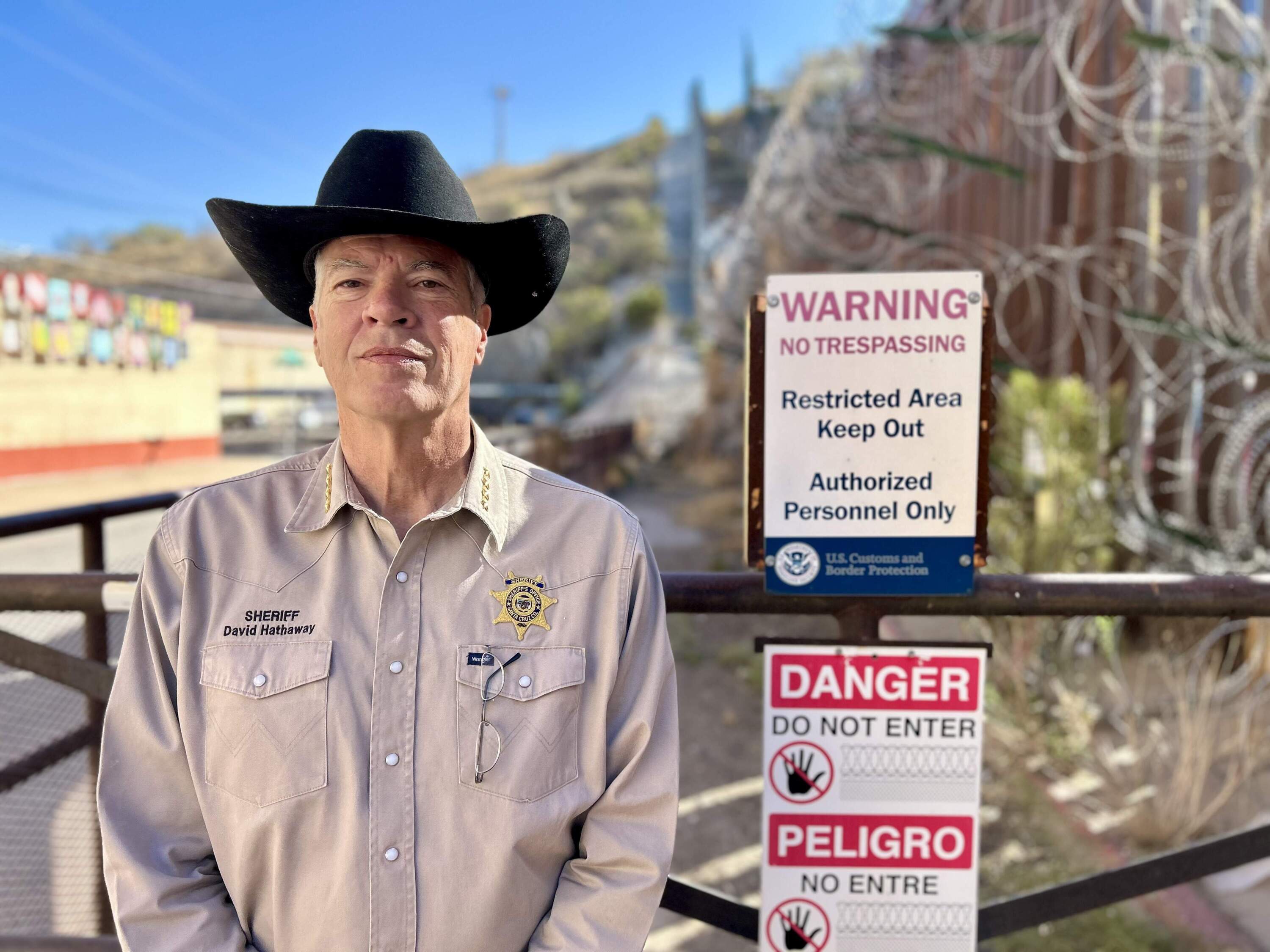 Santa Cruz Co. Sheriff David Hathaway at the border wall in Nogales, Arizona. (Peter O'Dowd/Here & Now)