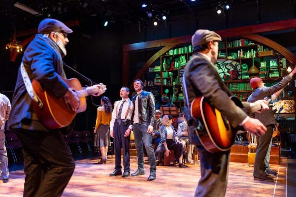 Eddie Shields and Keith Robinson (center) with the company of "A Man of No Importance." (Courtesy Nile Scott Studios)