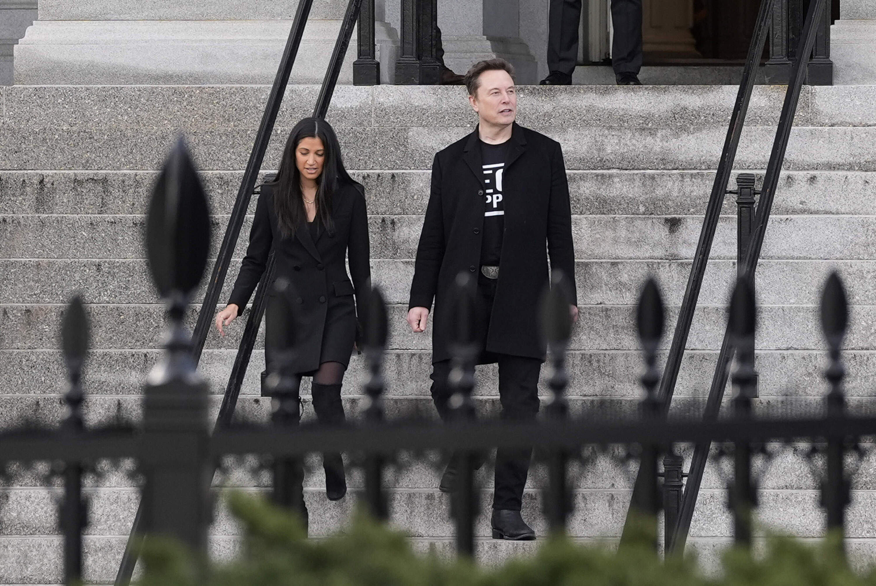 Elon Musk walks down the stairs from the Eisenhower Executive Office Building on the White House campus, Thursday, Feb. 13, 2025, in Washington. (Alex Brandon/AP)