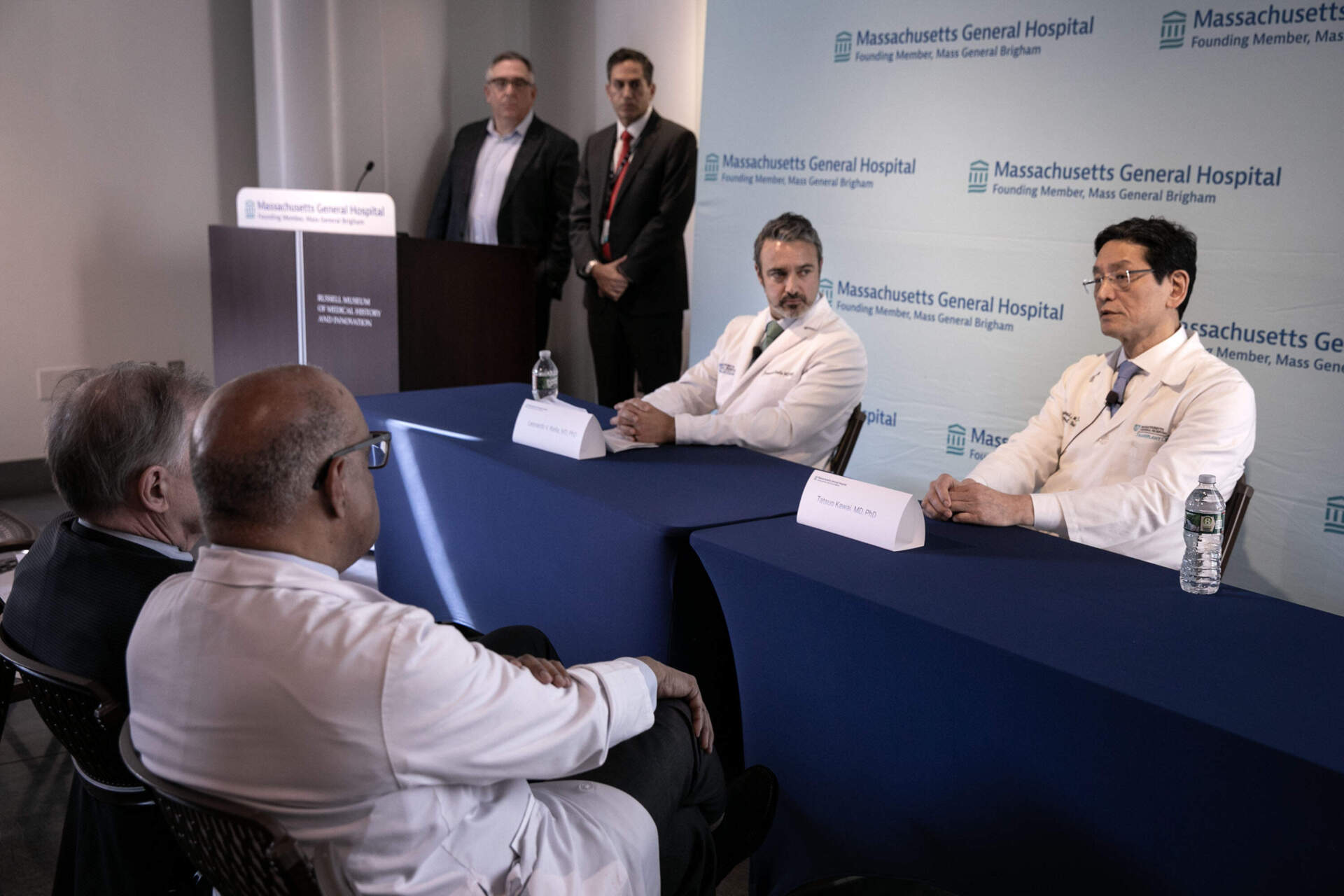 MGH nephrologist Leonardo Riella and surgeon Tatsuo Kawai talk with reporters about Massachusetts General Hospital's second transplant of a genetically edited pig kidney into a living human recipient. (Robin Lubbock/WBUR)
